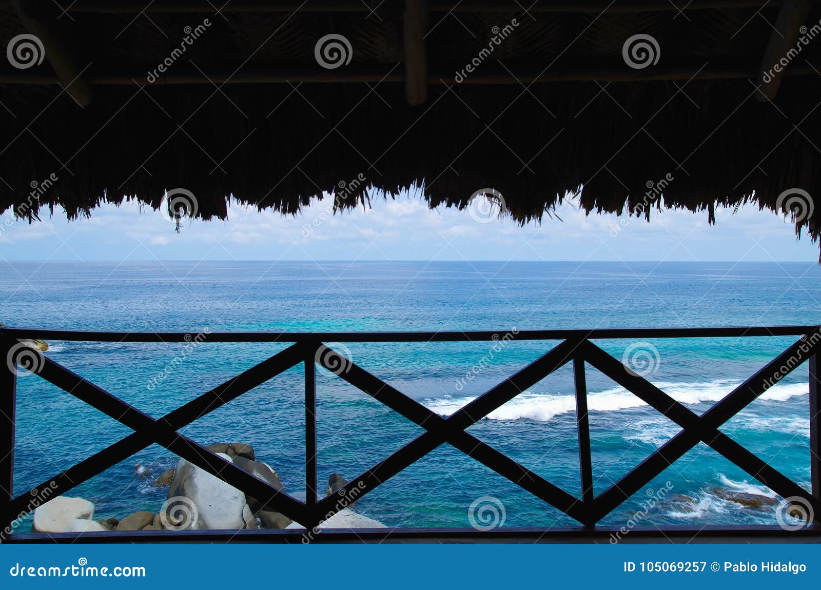 beautiful outdoor view of a ocean seen from inside of a bungalow in tairona national park, colombia