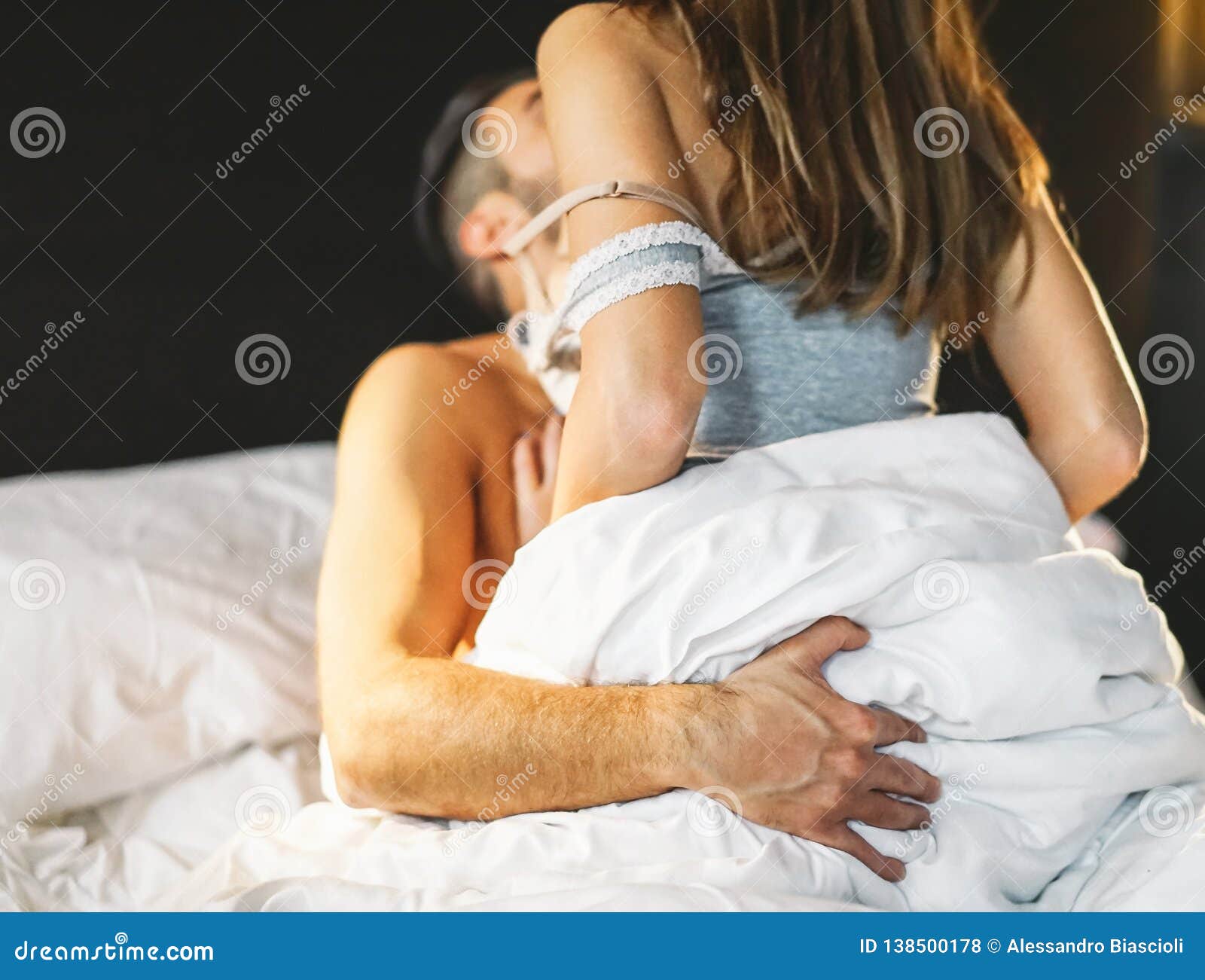 Beautiful Passionate Young Couple Having Sex on the Bed at Home - Intimate and Sensual Moments of a Couple Making Love Stock Photo