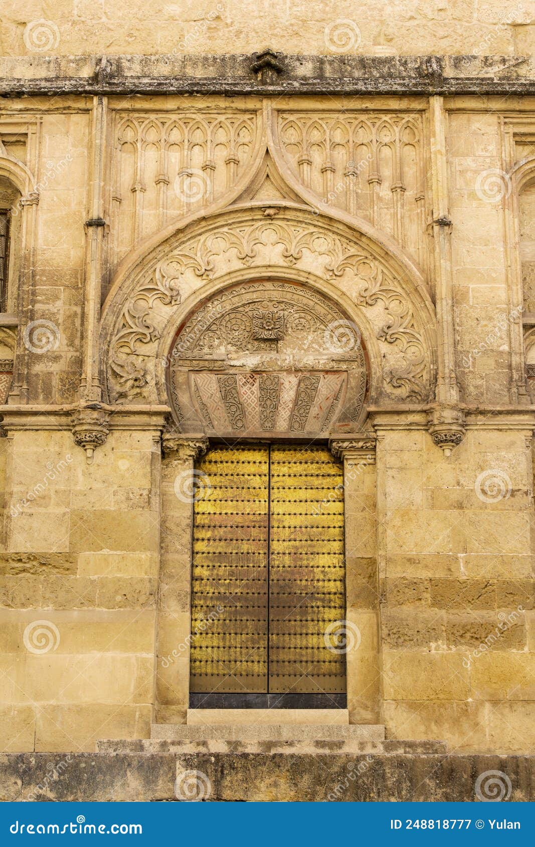 beautiful patterns of the exterior wall with gate of the magnificent mosque of cordoba.