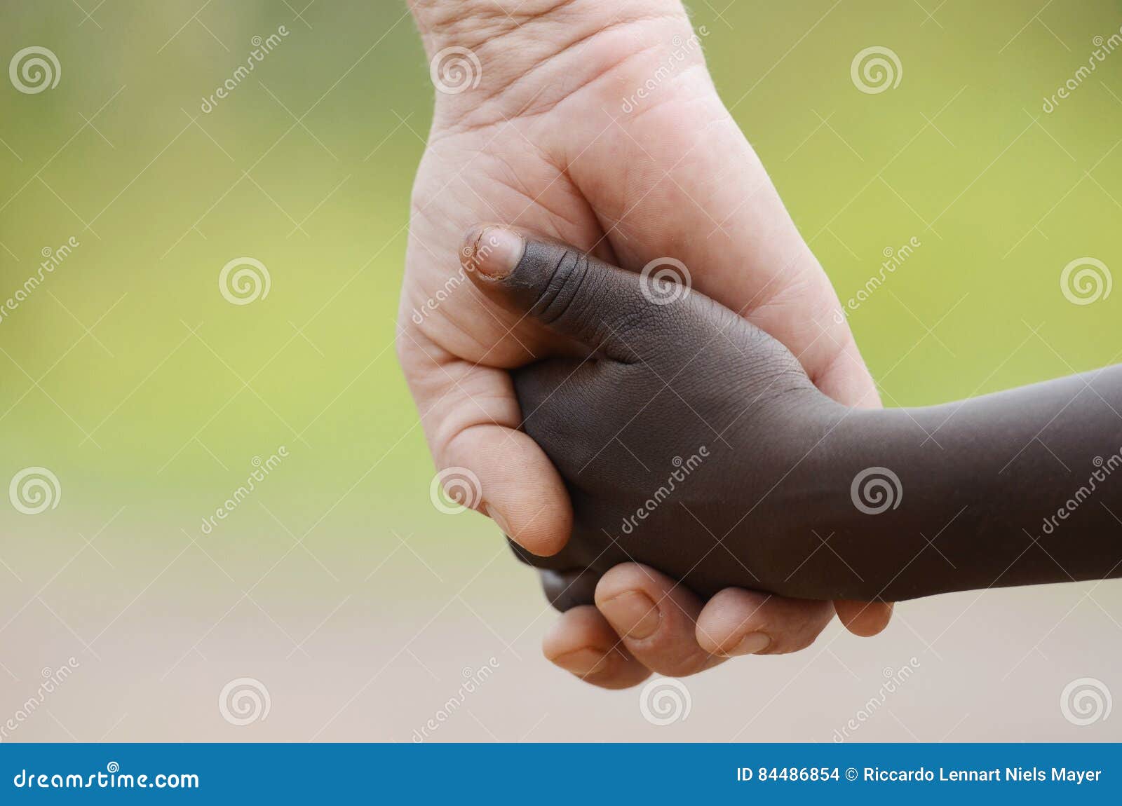 beautiful peace  - white woman black child holding hands.