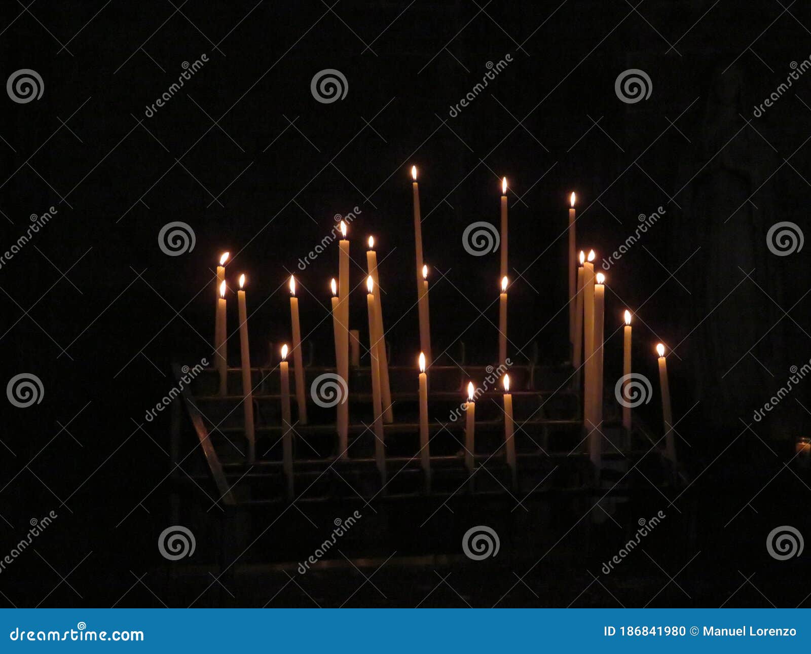 beautiful photo of candles in a church lit for the feeling