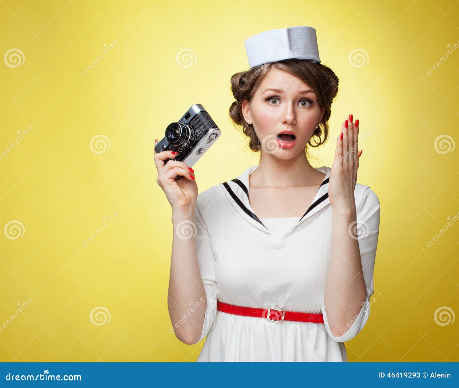 Beautiful Pin Up Girl Dressed A Sailor Holding A Vintage Camera And Screams Behind His Hand