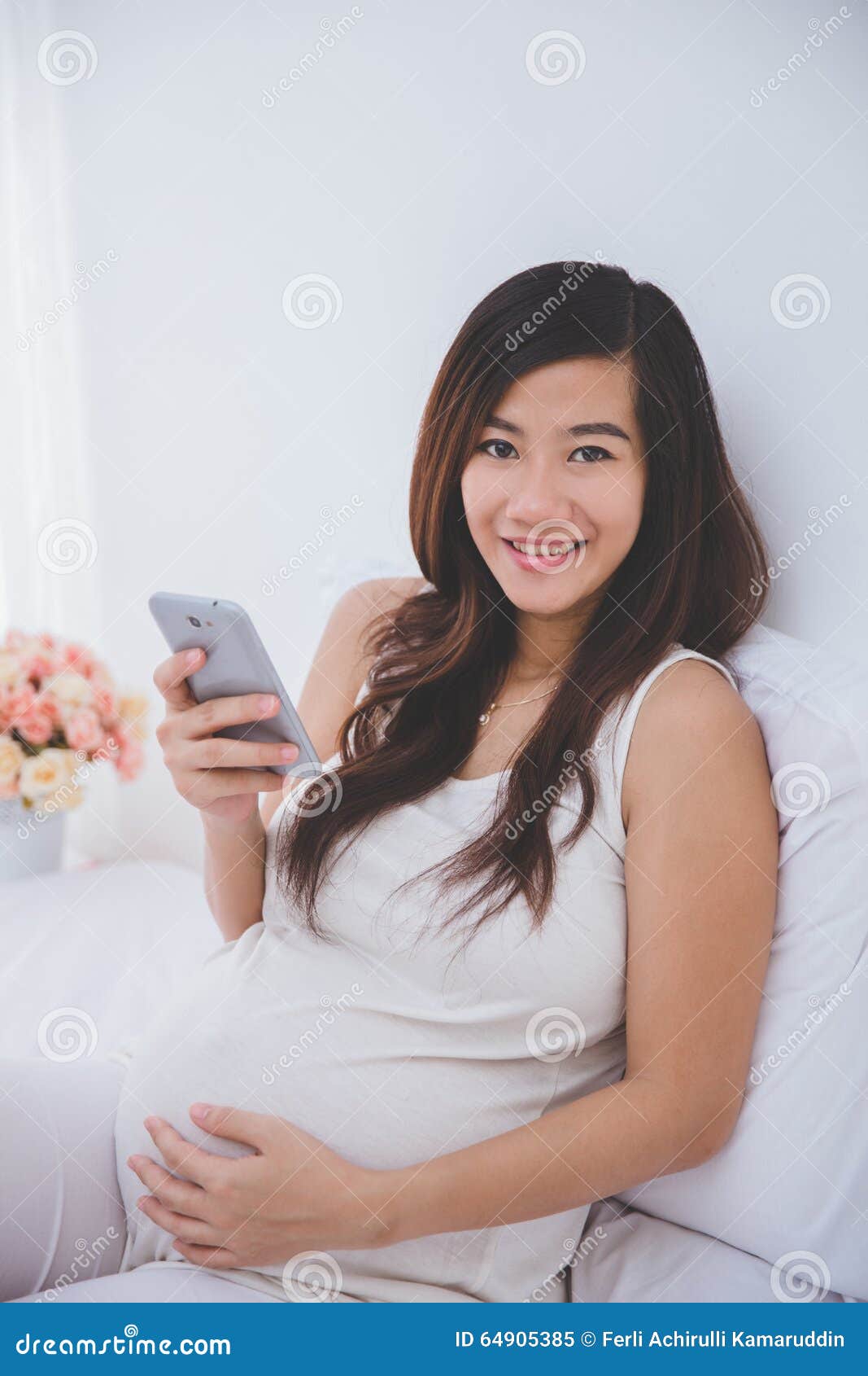 Beautiful Pregnant Asian Woman Usin