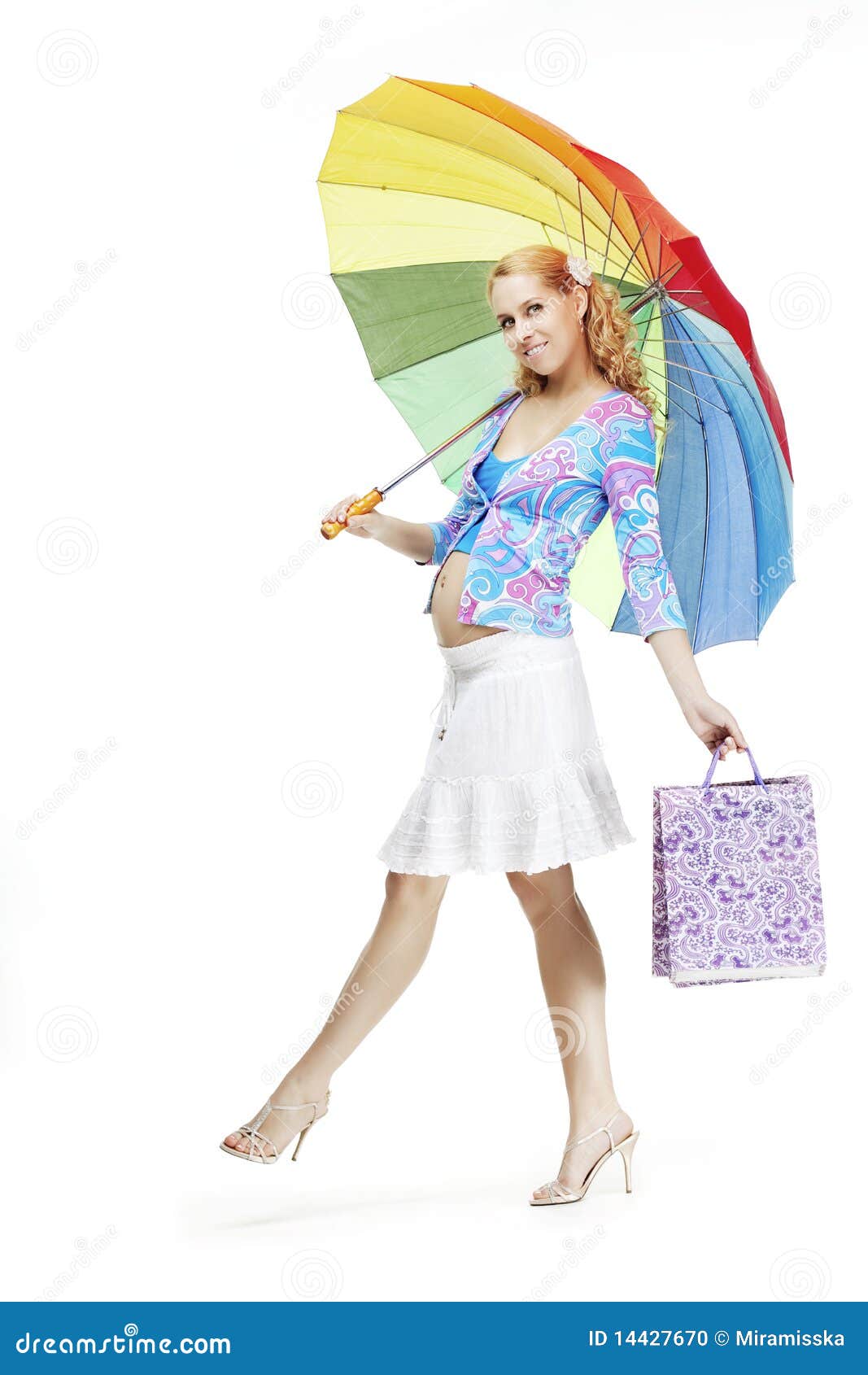The image of a beautiful pregnant girl with a rainbow umbrella