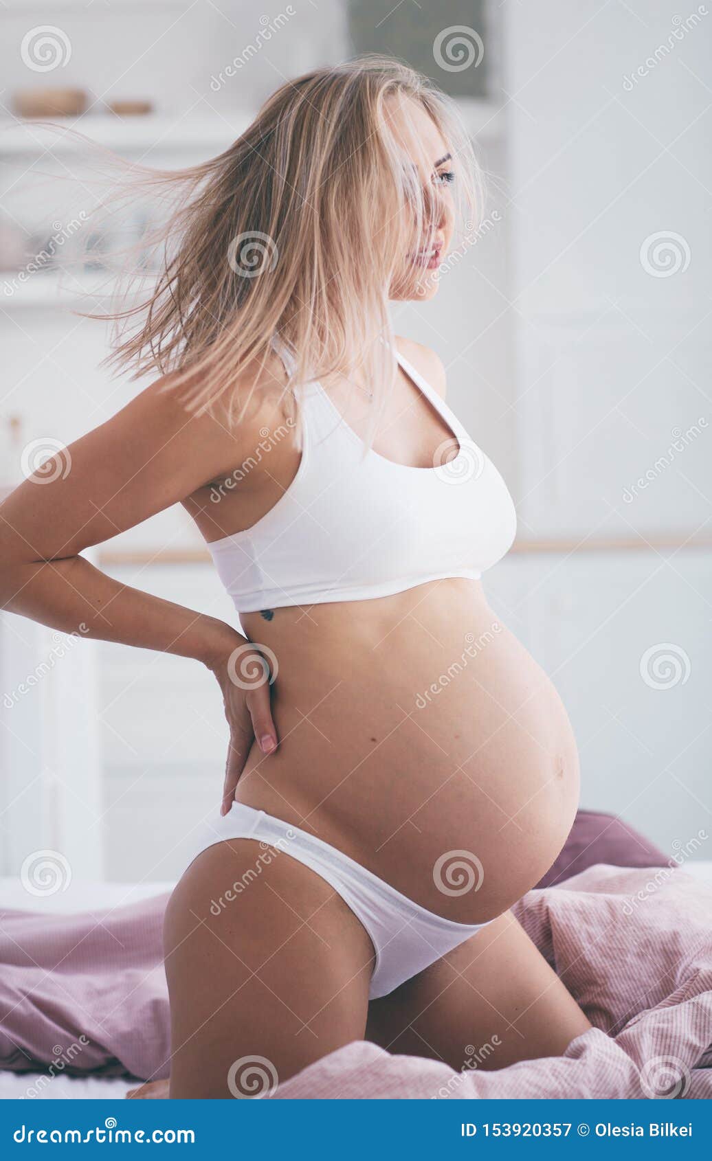 Beautiful Pregnant Woman in Underwear Stretching on the Bed in the Morning  Stock Image - Image of awake, human: 153920357