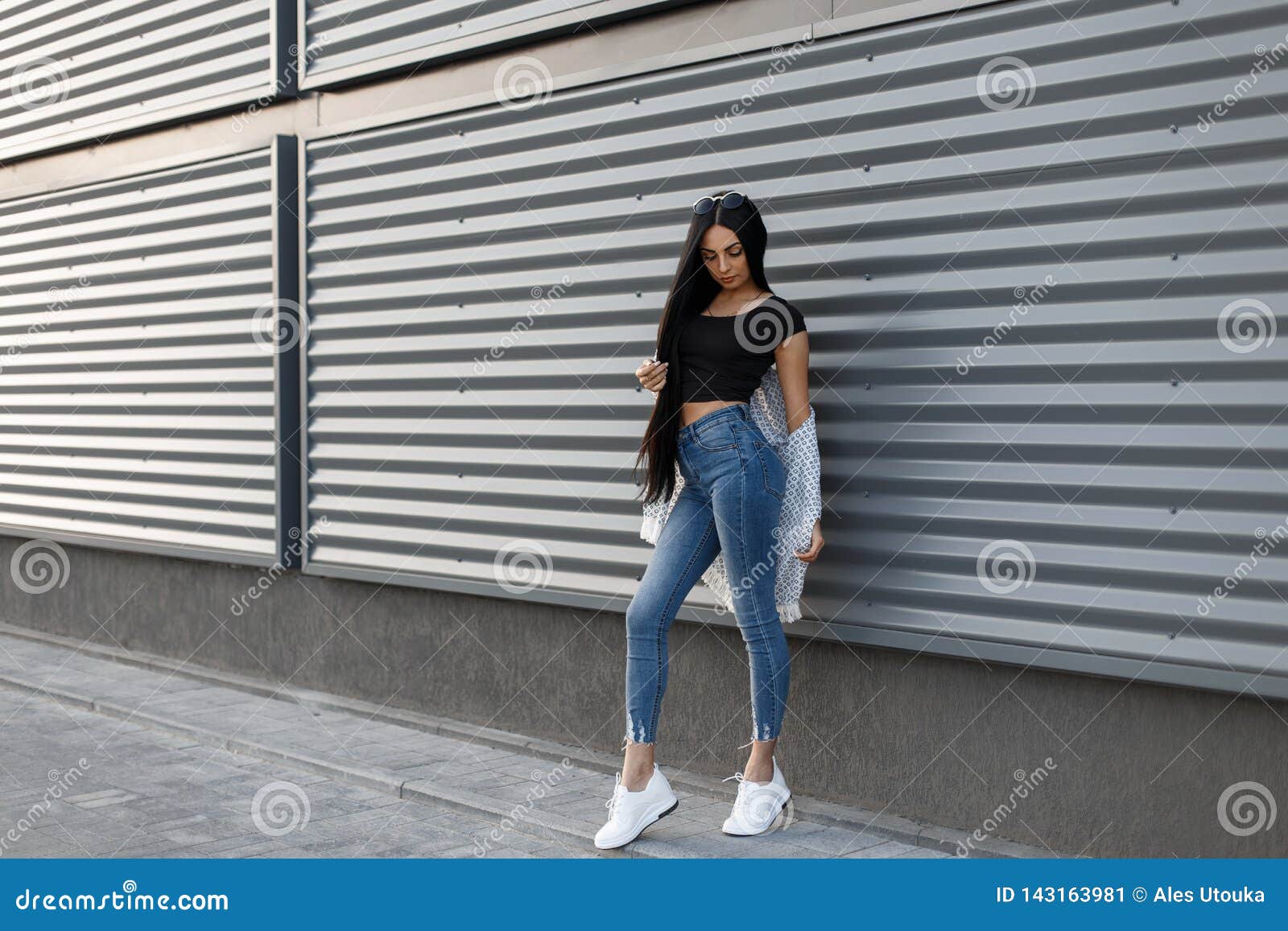 Trendy Coat with Skinny Jeans and Sneakers - Brunette from Wall Street