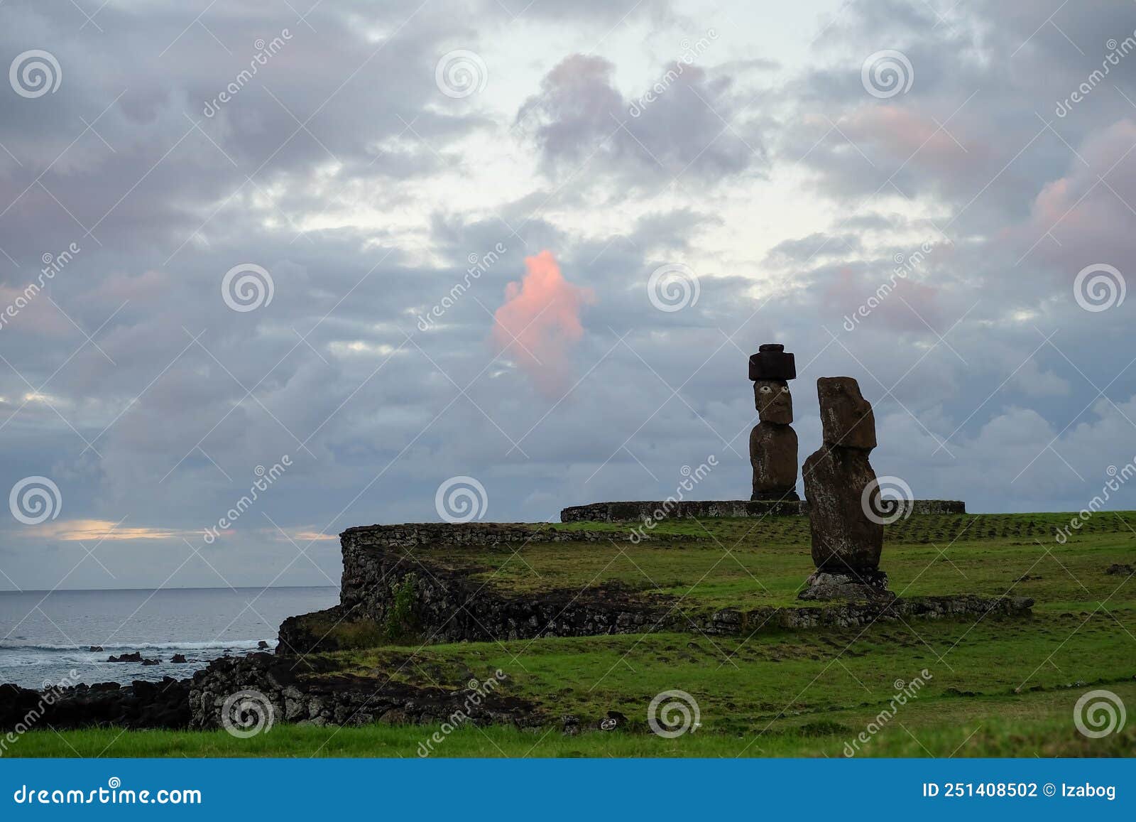 beautiful sunset over moai statues in hanga roa