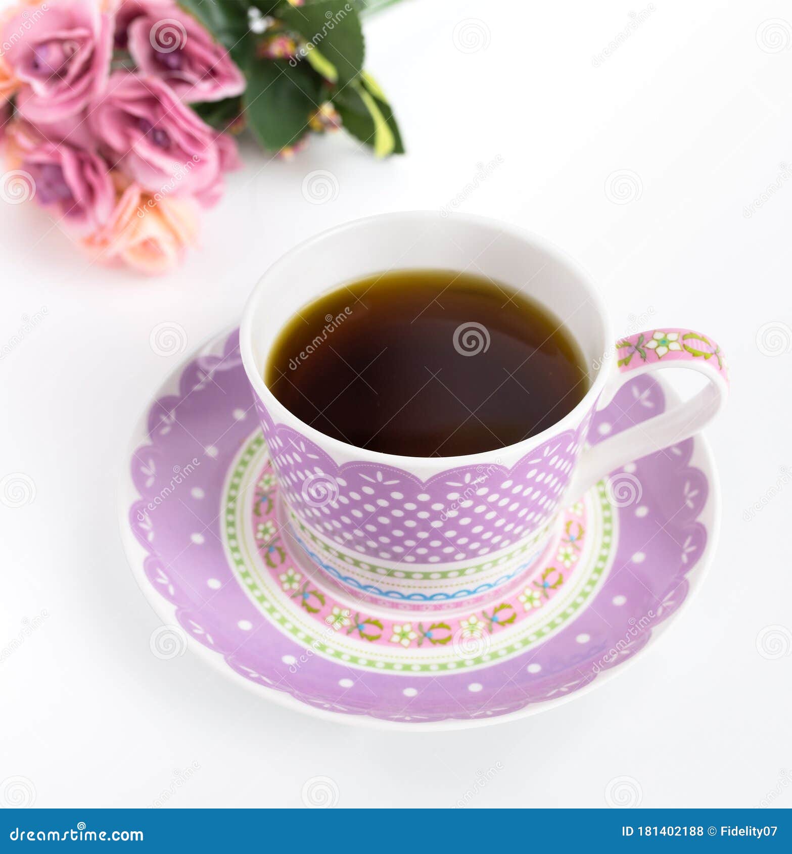 Beautiful Purple Tea Cup with Roses in Background Stock Photo Image
