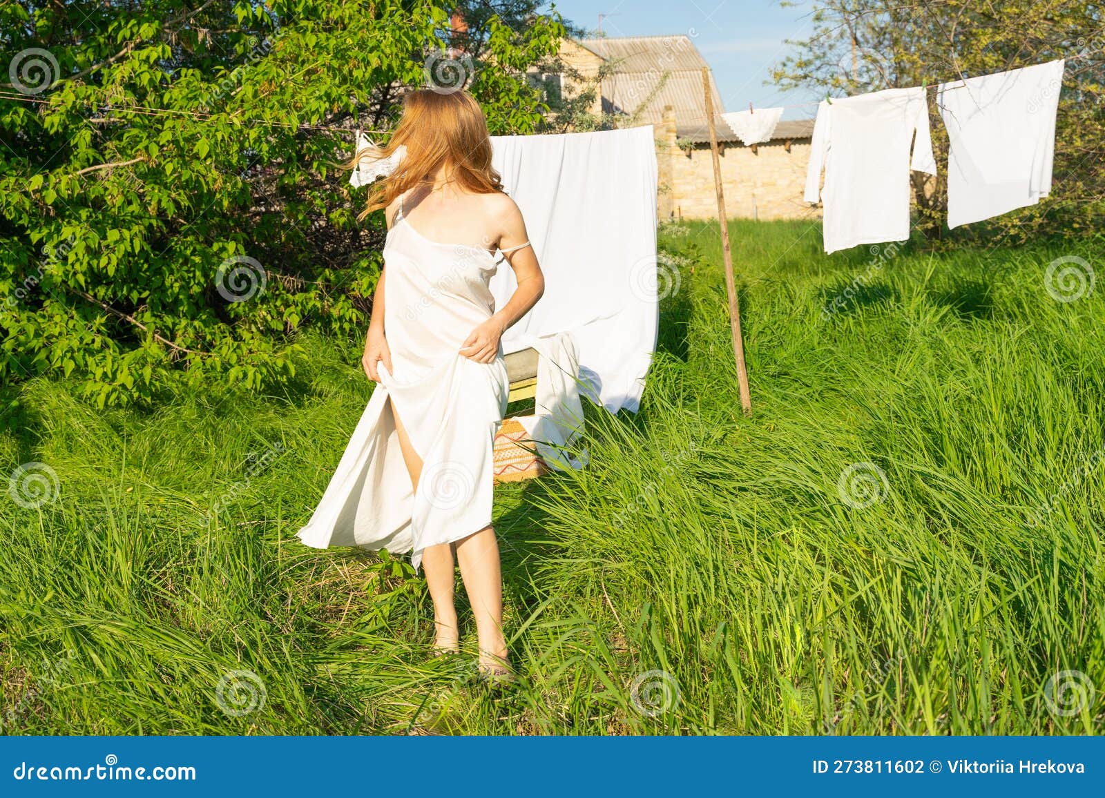 Beautiful Red Girl in Nightie Hanging Laundry Outdoors. Village Woman ...