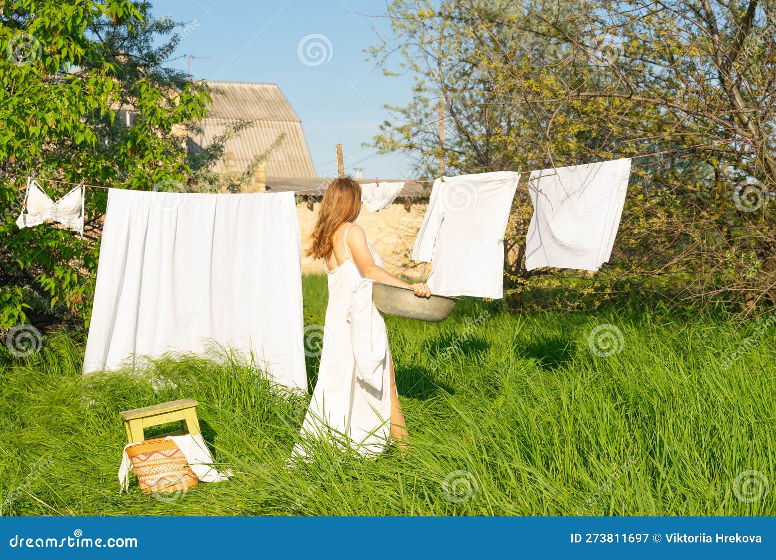 Beautiful Red Girl in Nightie Hanging Laundry Outdoors. Village Woman ...