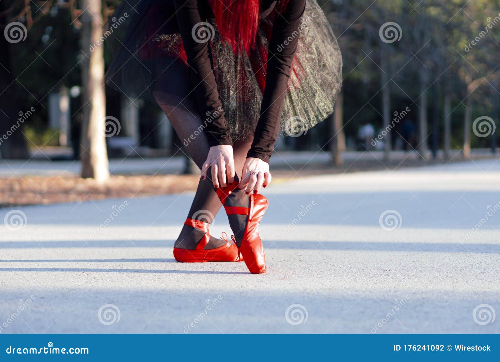 Beautiful Red Haired Ballerina Putting on Her Red Pointe Shoes at a ...