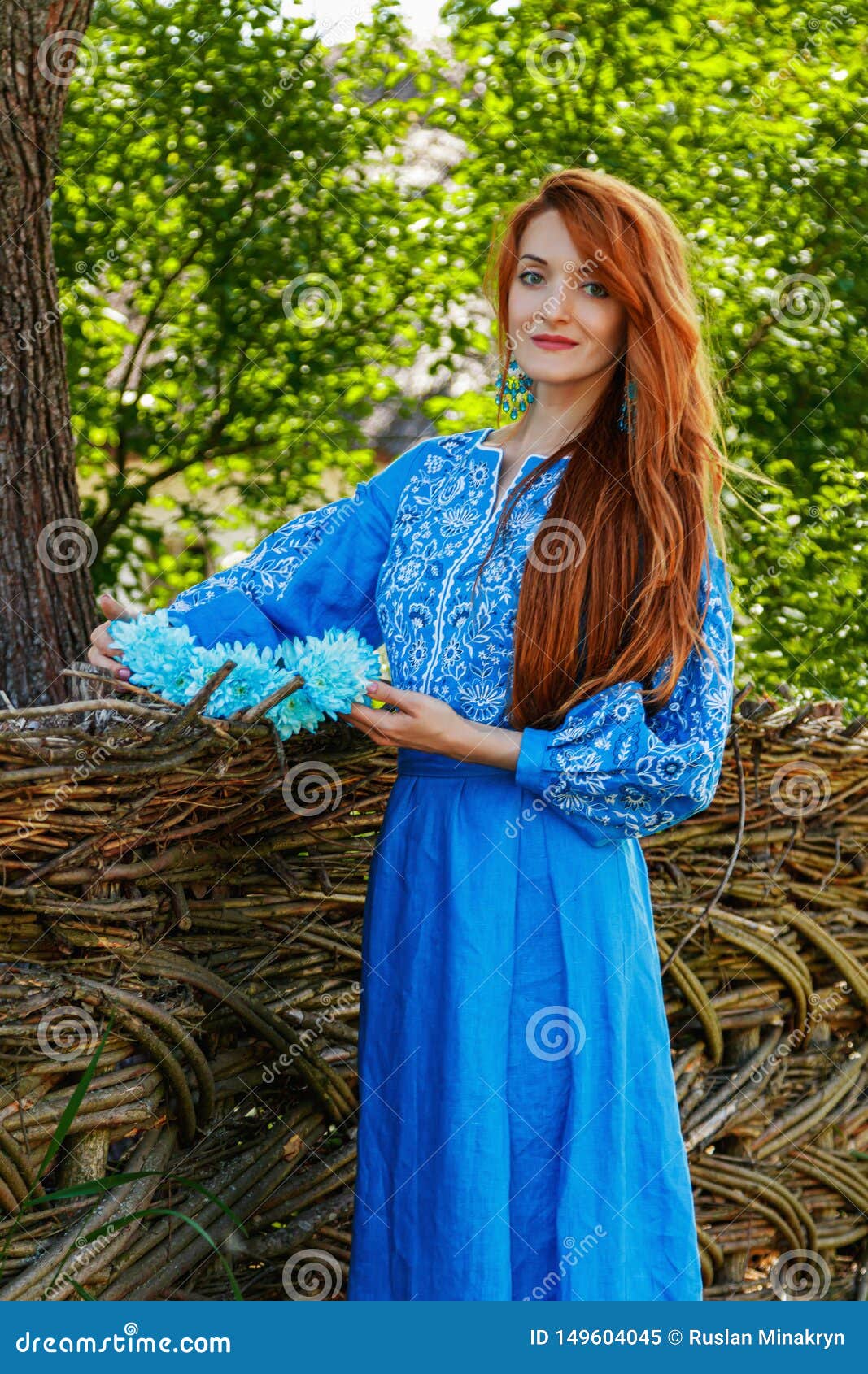Beautiful Red-haired Girl in a Blue Dress Ukrainian with a Wreath on ...