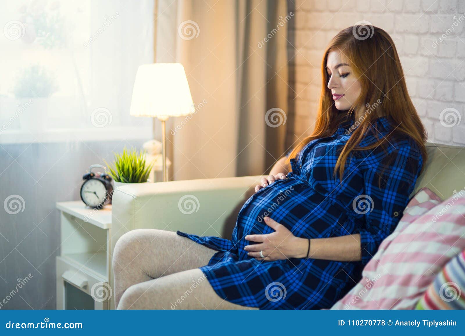 Beautiful Red-haired Young Pregnant Woman Sitting At Home 
