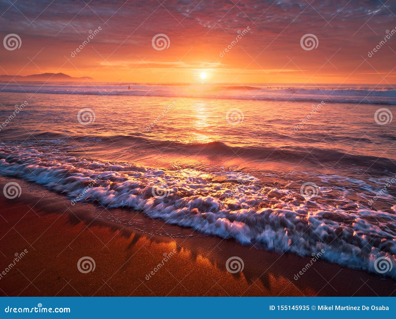 Beautiful Red Sunset On Beach With A Wave Stock Image