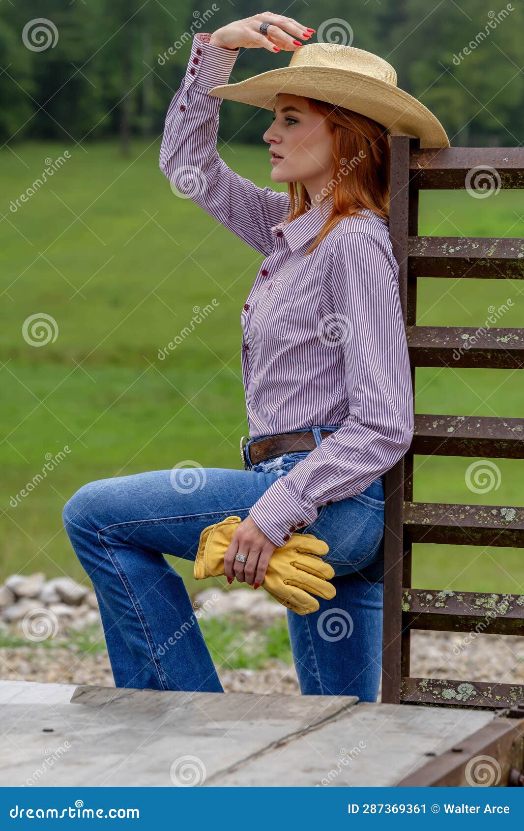 A Lovely Red Headed Country Wetern Model Poses Outdoors in a Country ...