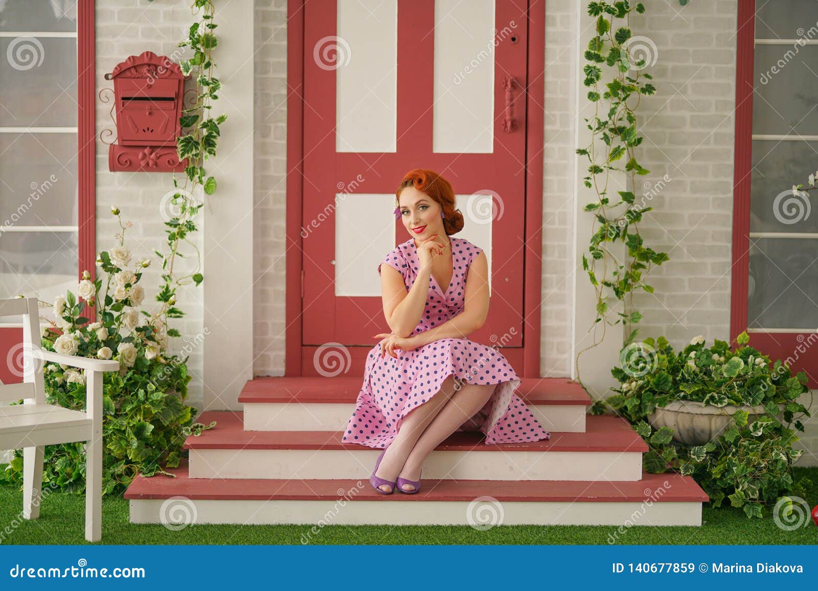 Beautiful Redheaded Pin Up Girl In Pink Polka Dot Dress And Vintage