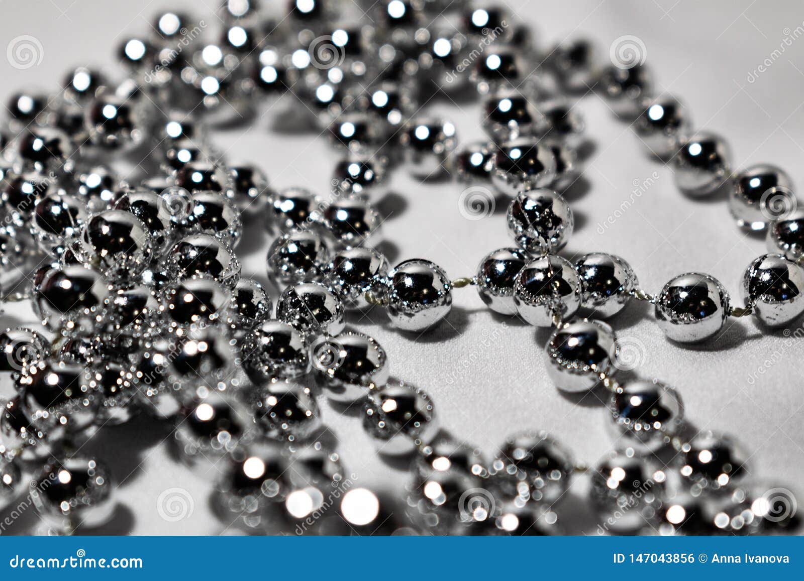Beautiful Round Silver Beads and Beads on White Fabric Background ...