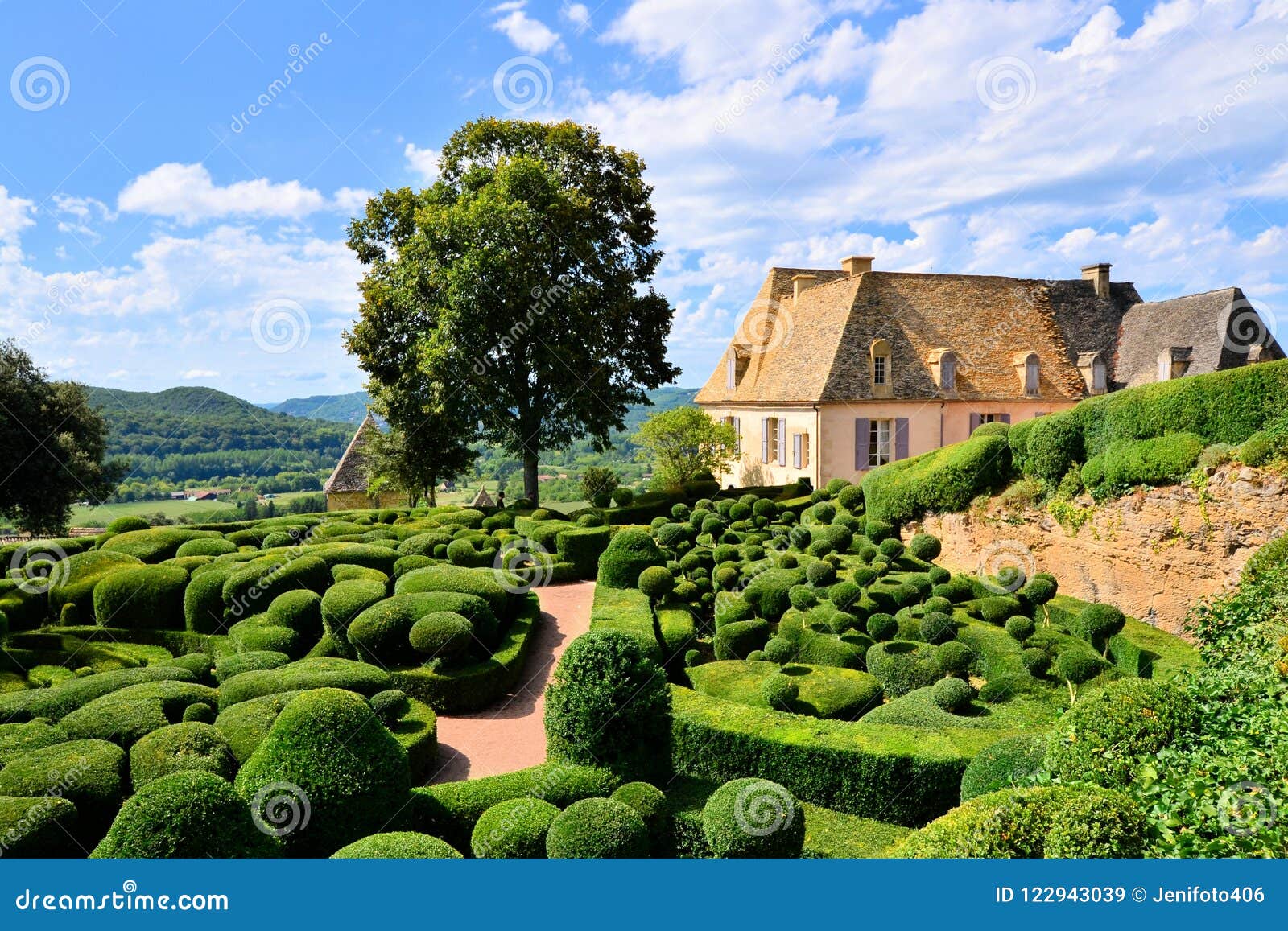 sculpted gardens with house, dordogne, france