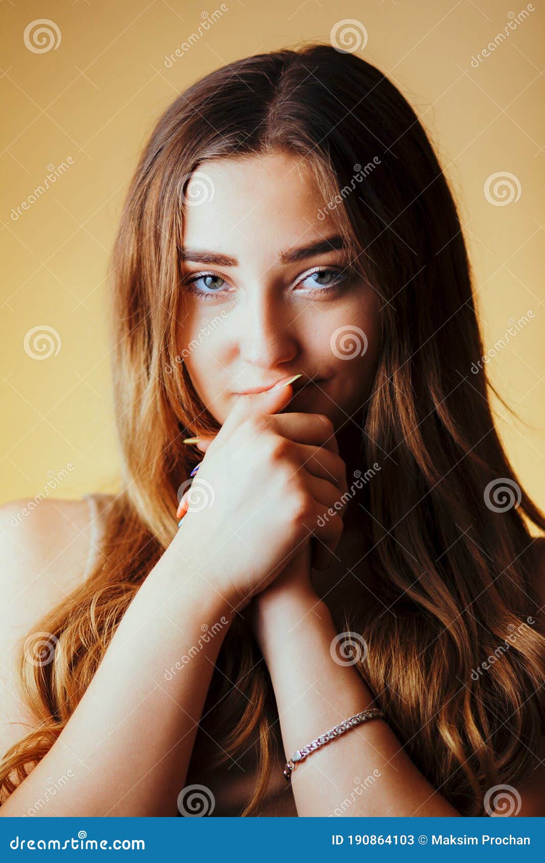 Beautiful Seductive Girl with Hands Near Face on Orange Colored ...