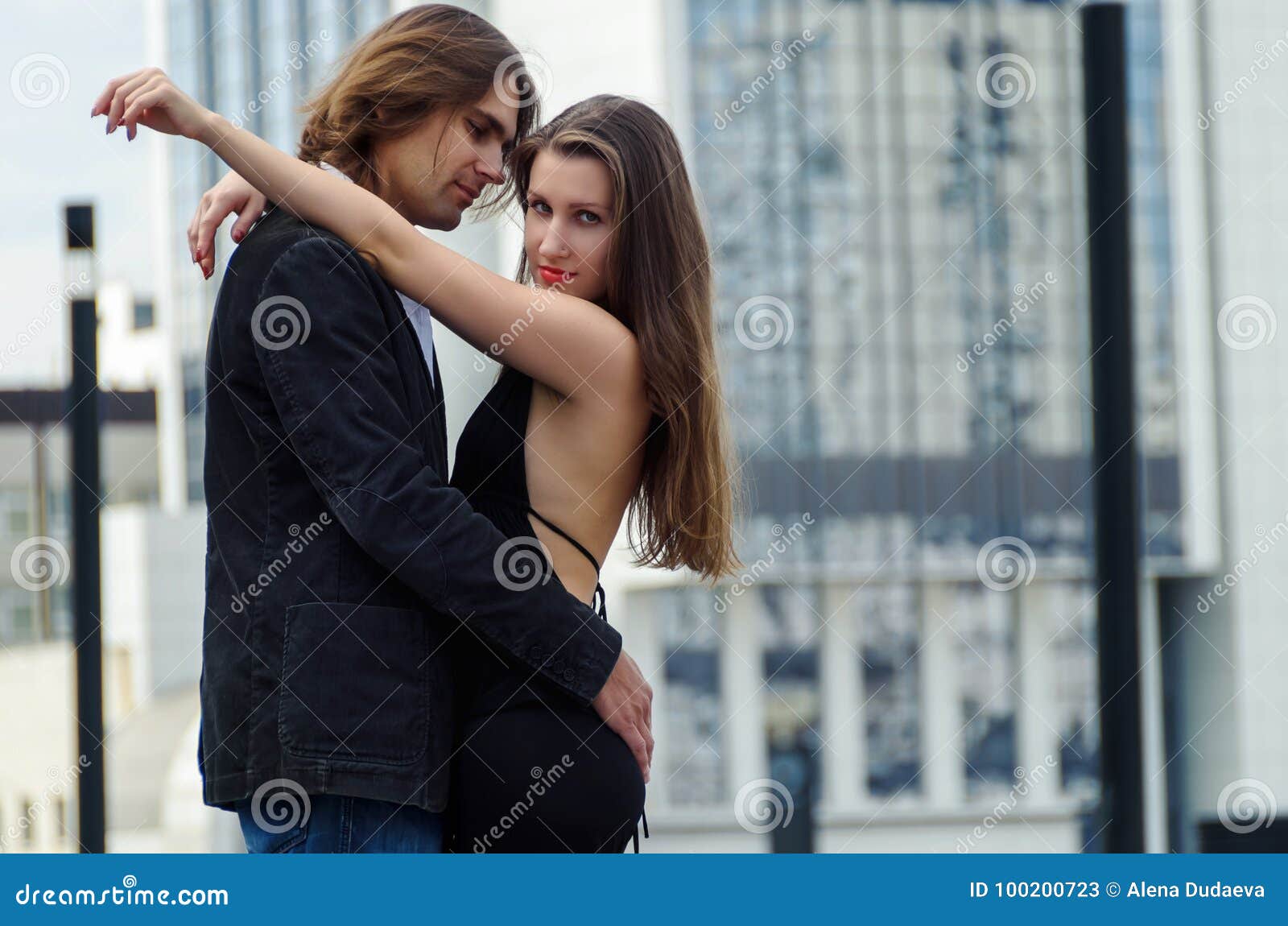 Beautiful Sensual Elegant Couple Stands On A City Street And Embraces