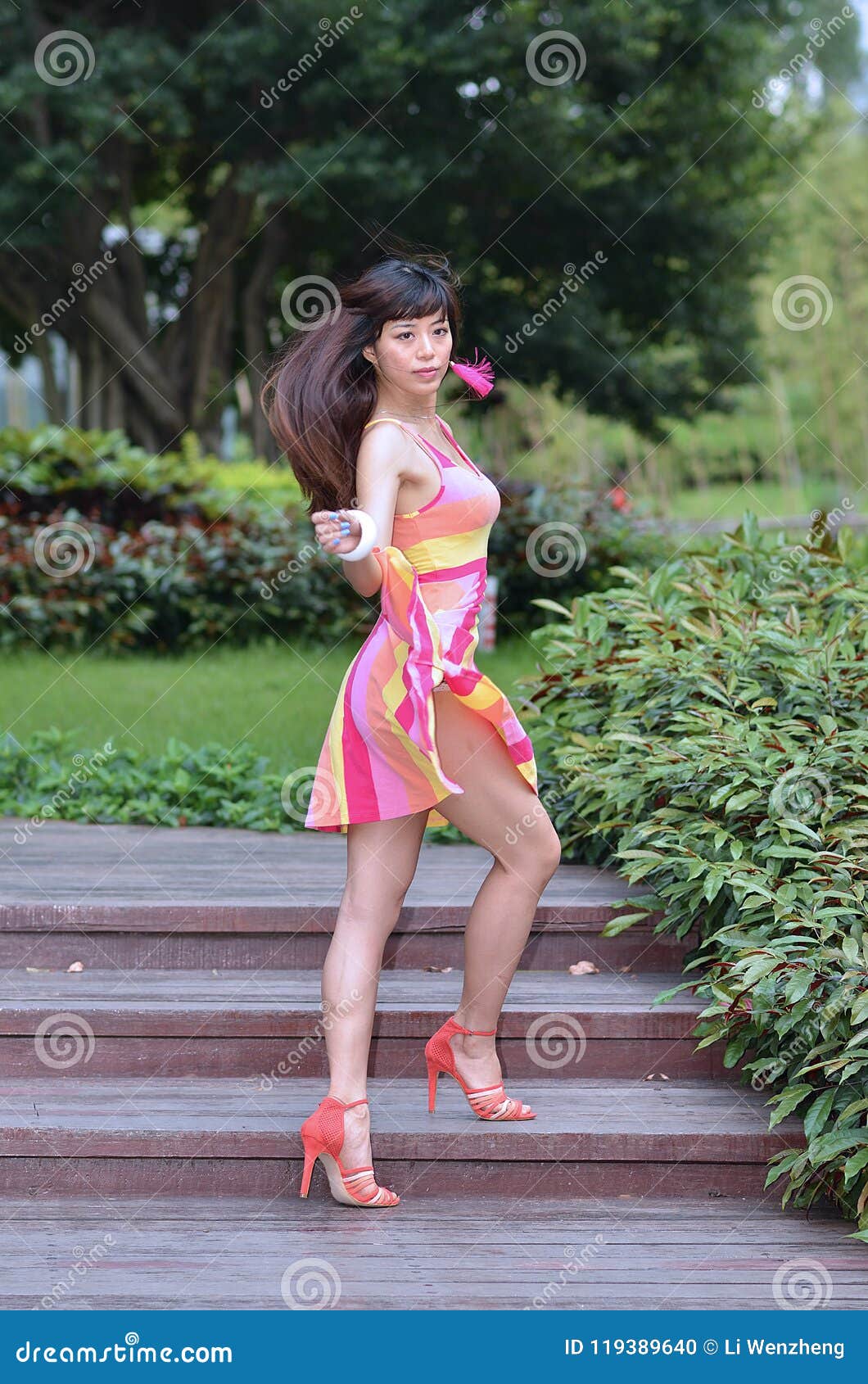 Beautiful and Sex Asian Girl Shows Her Youth in the Park Stock Photo