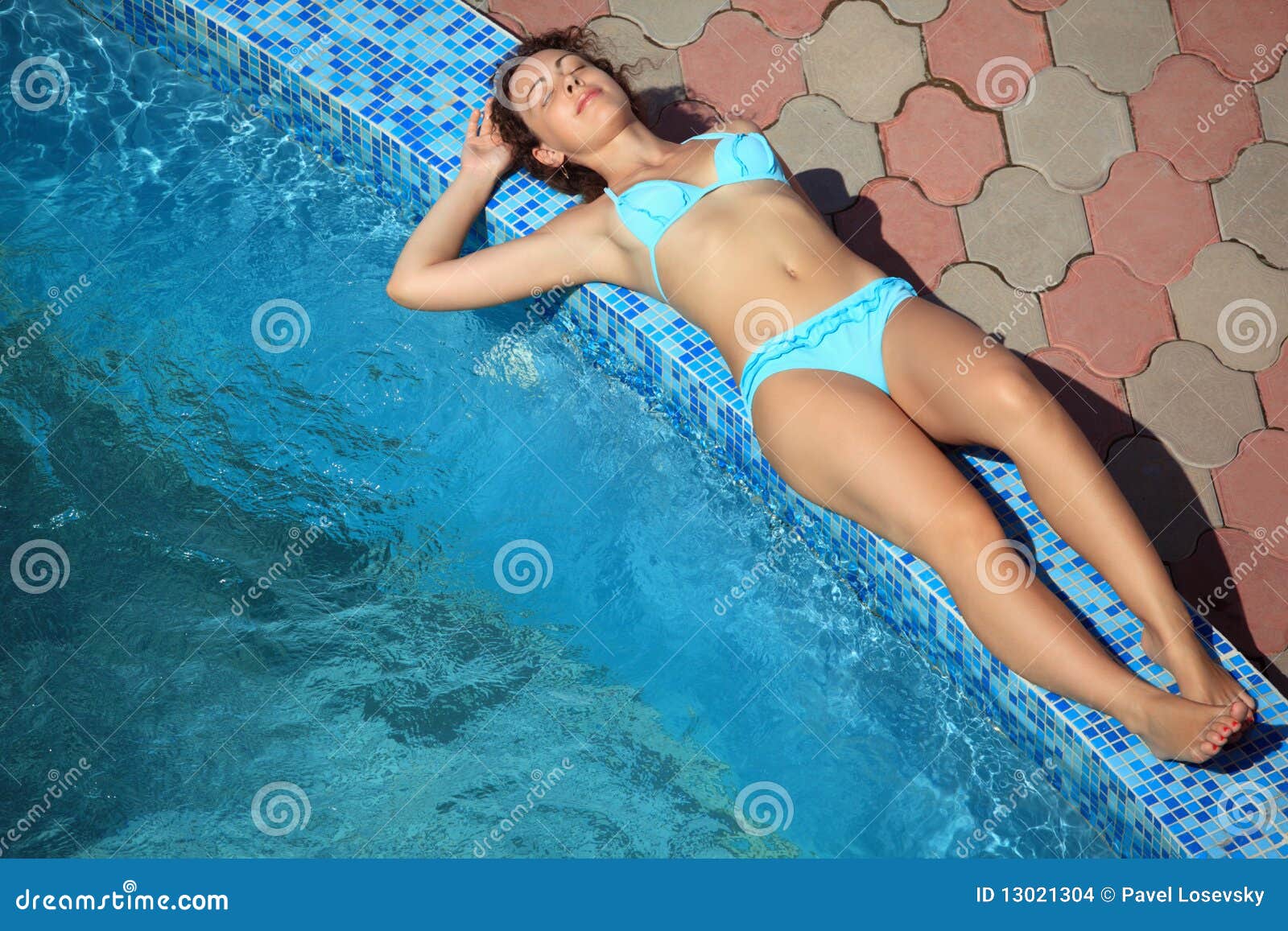 beautiful sexual woman lying near pool on resort