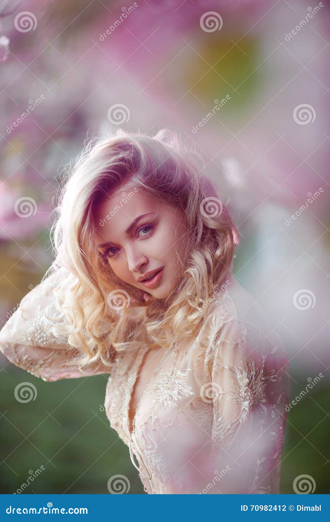 Beautiful Adult Girl Standing At Blossoming Tree In The Garden Stock