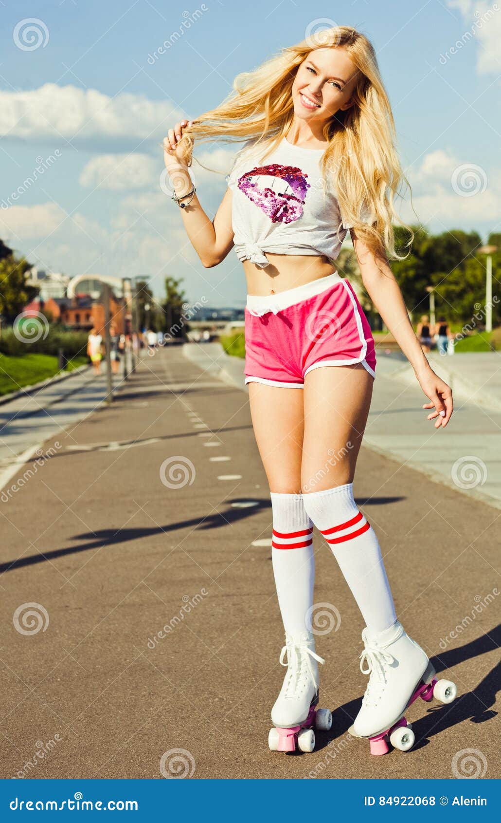 A Looker Leggy Long-haired Young Blonde Woman in a Vintage Roller Skates,  Sunglasses, T-shirt Shorts Sitting on Road. Eye-candy Yo Stock Photo -  Image of american, happy: 84896256