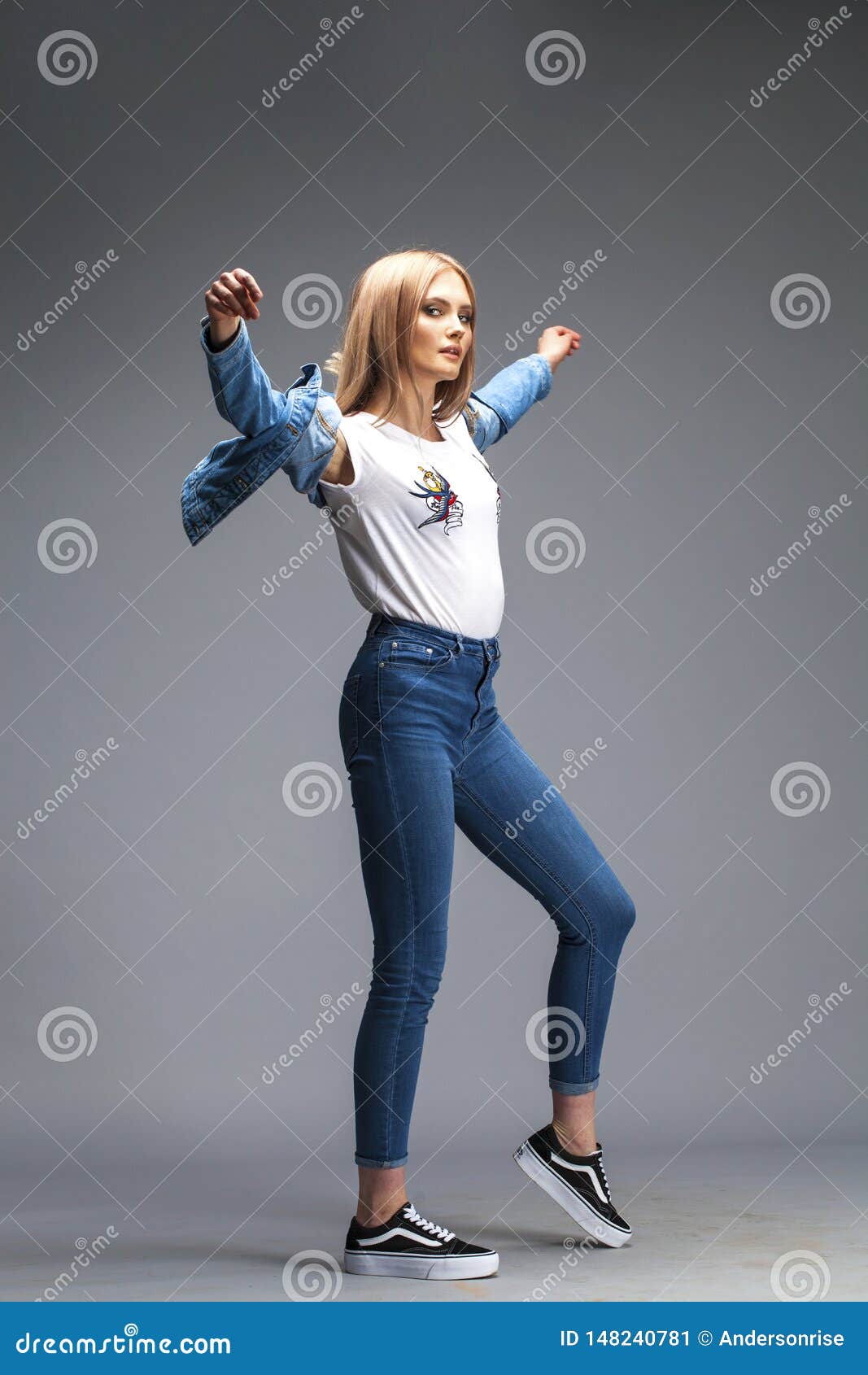 Beautiful Blonde Woman Dressed In A Denim Jacket And Blue Jeans Stock ...