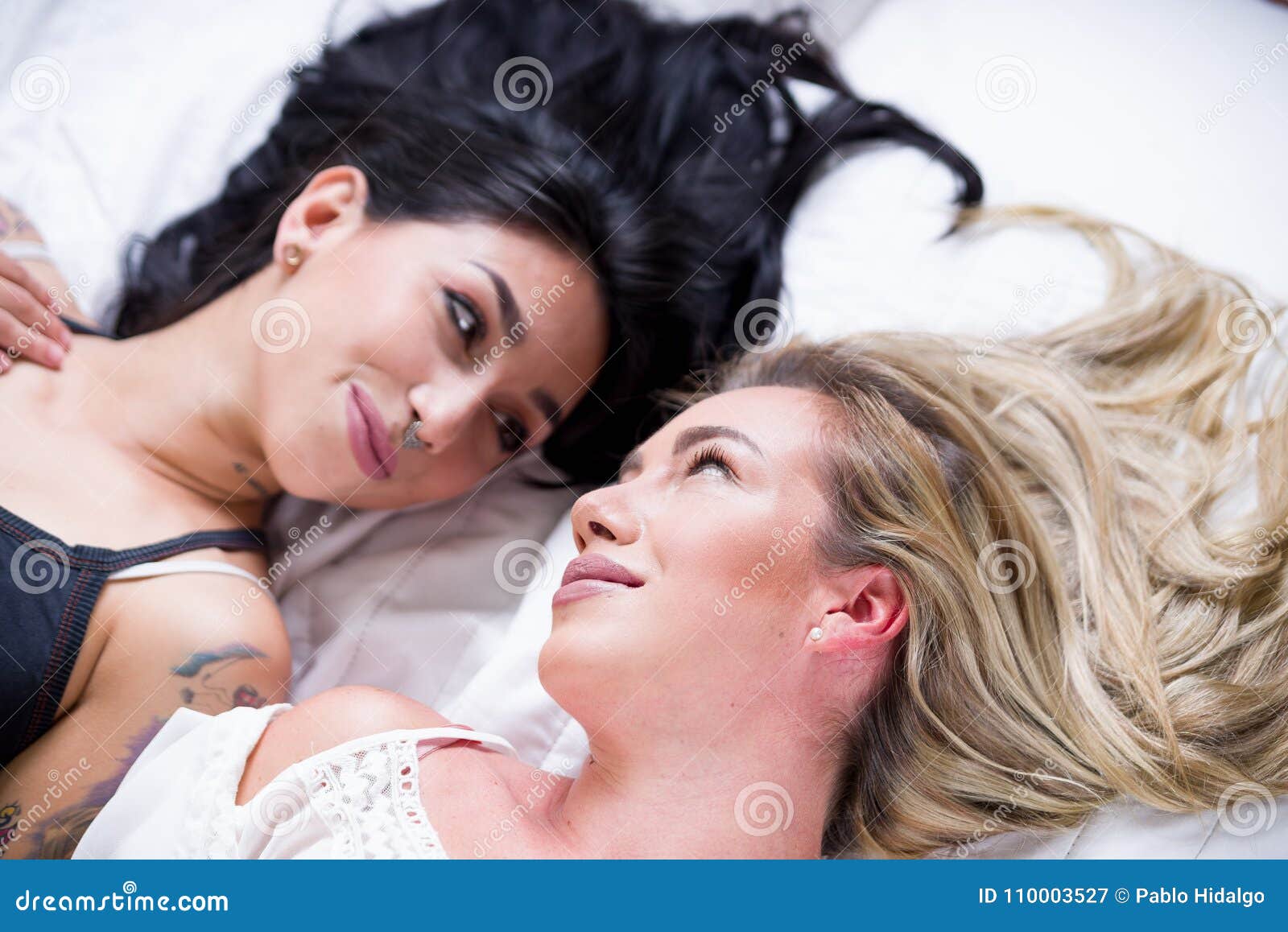 Beautiful Lesbians Lovers At Morning Laying In Bed Doing A Heart