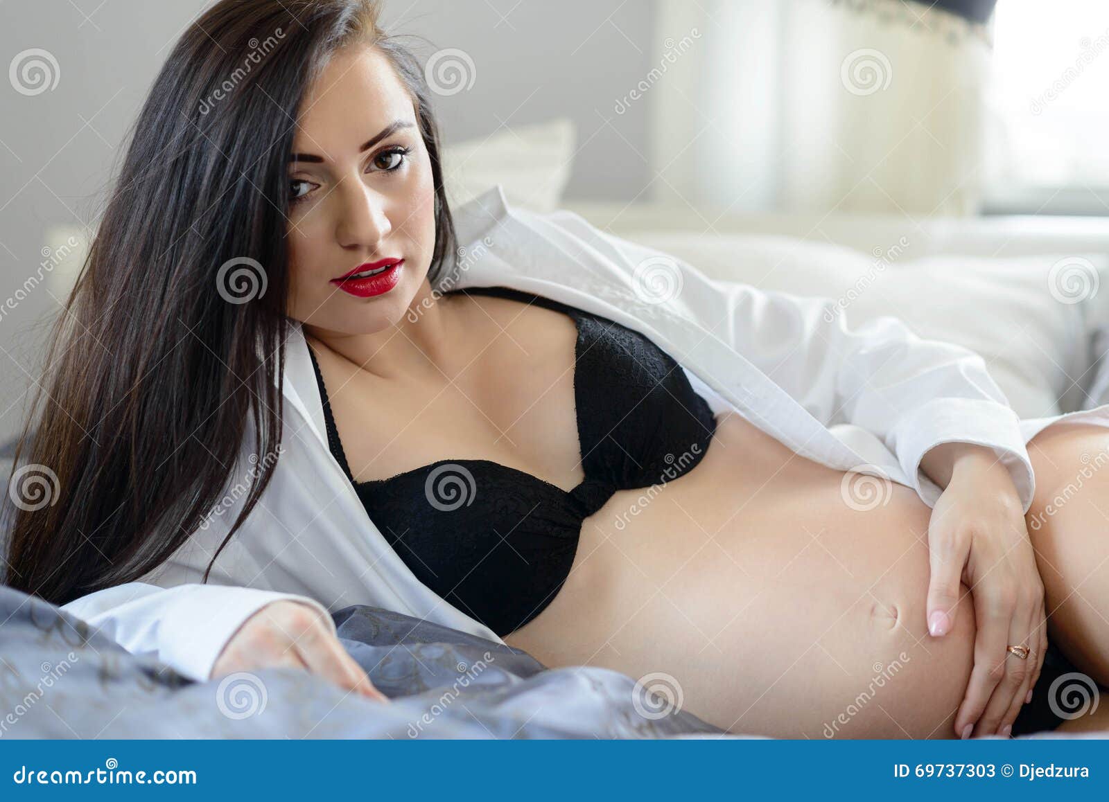 Beautiful Pregnant Woman on Bed Stock Image