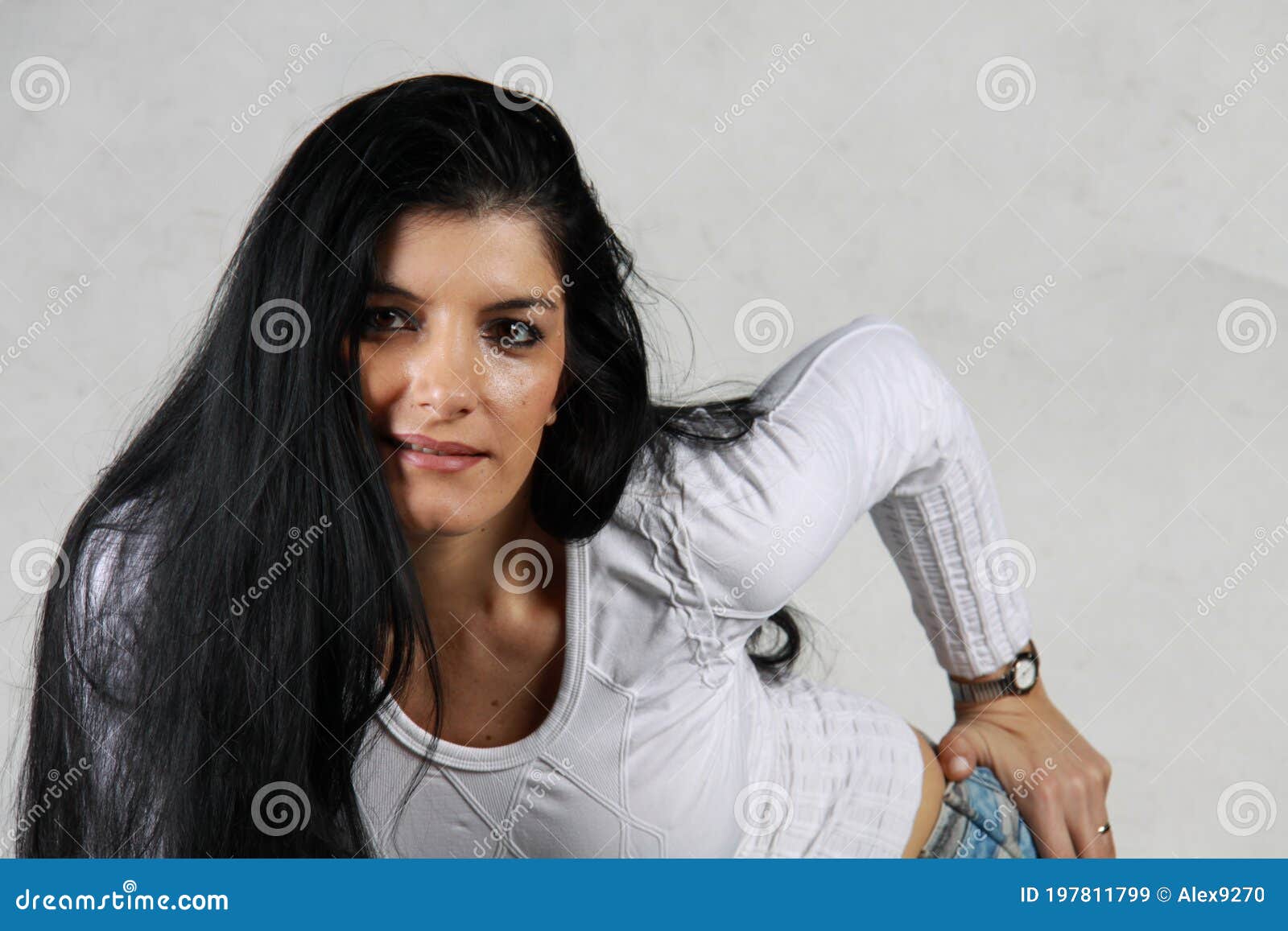 Attractive Sexy Blonde In Black Corset And Male White Shirt Posing  Provocatively. Portrait Of Sensual Woman Sitting On Wooden Cabinet Against  A Yellow Wall. Beautiful Fair Hair Fashionable Female Stock Photo, Picture