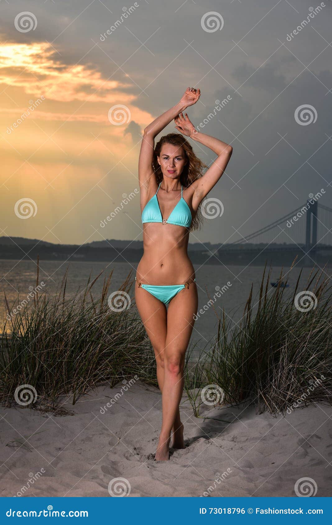Beautiful Young Woman with Perfect Slim Body in Bikini Posing on