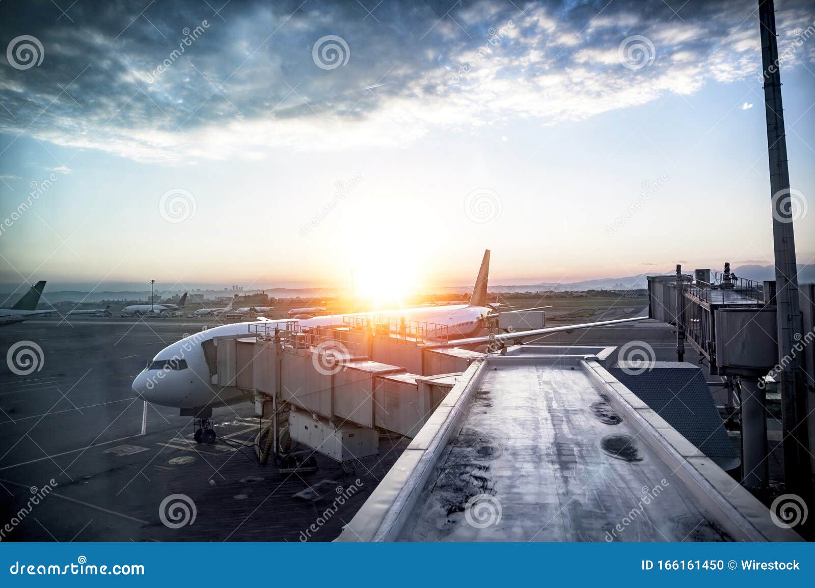 beautiful shot of an airplane at the station with the sun shining in the background