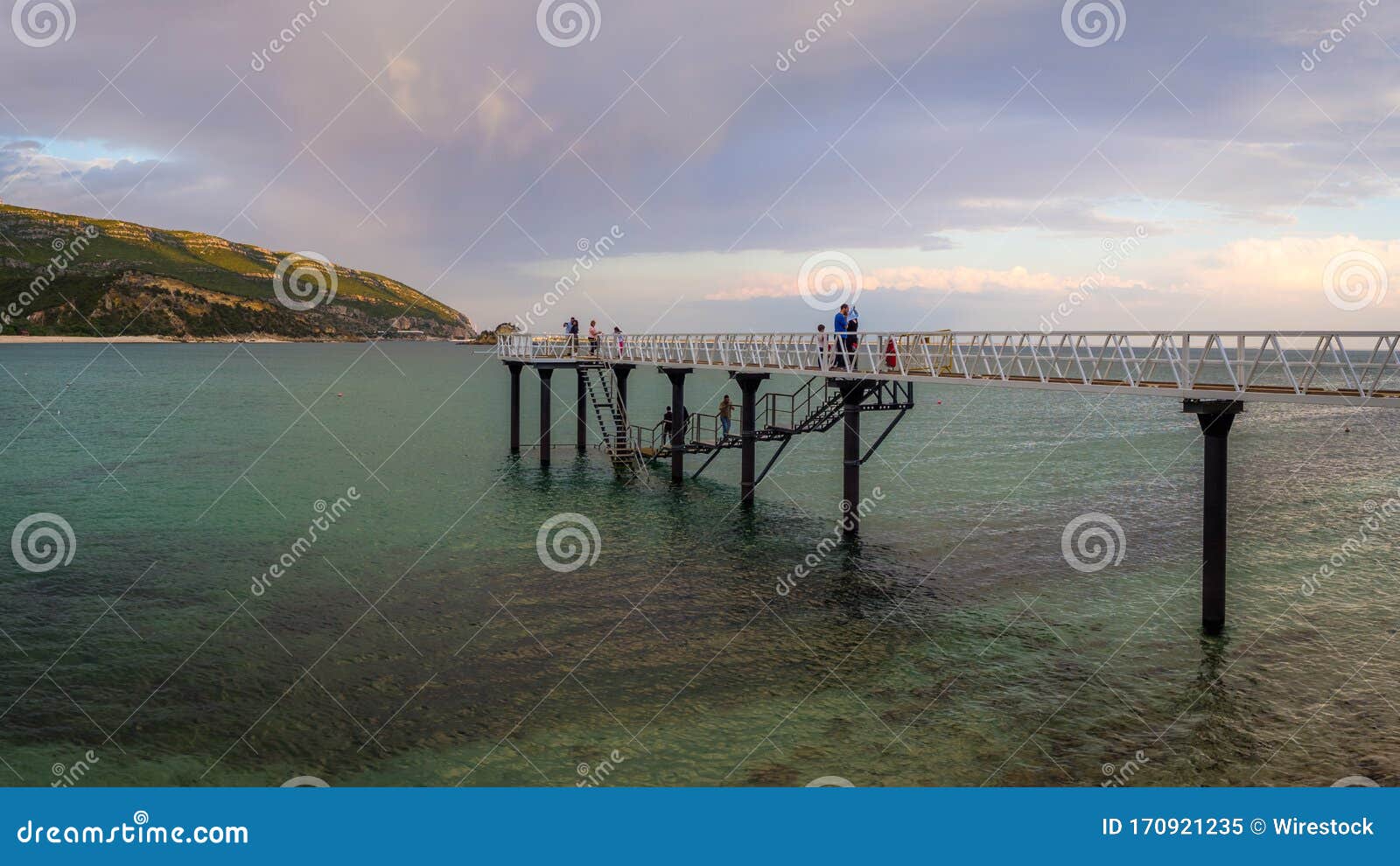 beautiful shot of people on the harbor in parque natural da arrÃÂ¡bida, casal, portugal