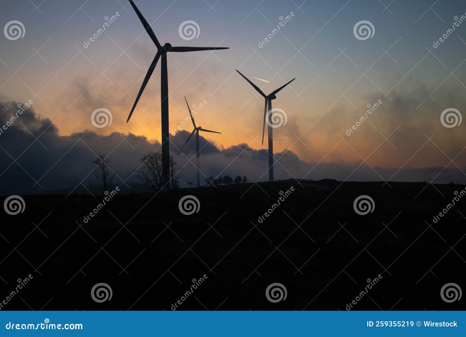 Beautiful Shot Of Windmills In A Field During The Sunset Stock Image