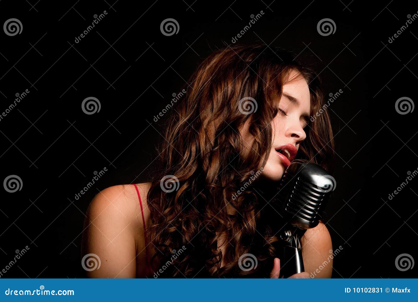 beautiful singer singing with microphone