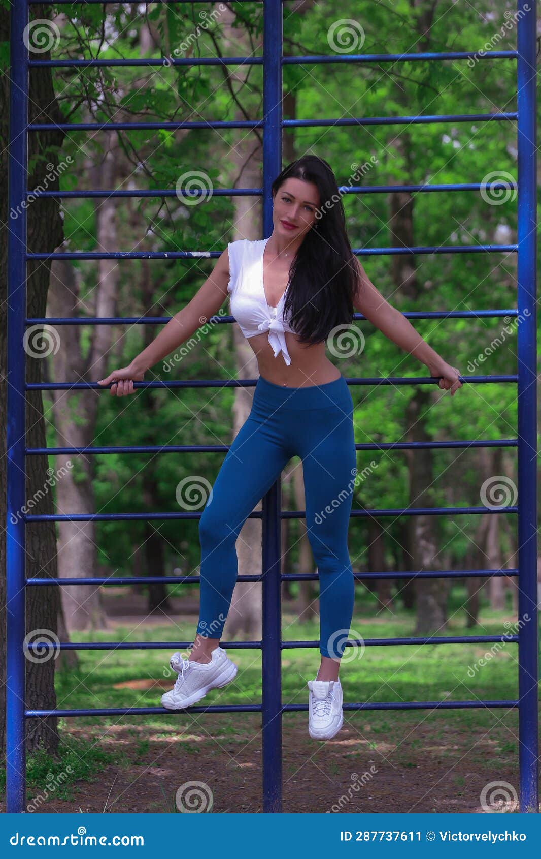 A Beautiful Slender Brunette Girl Athlete Coach Is Engaged On The Street Platform Stadium In