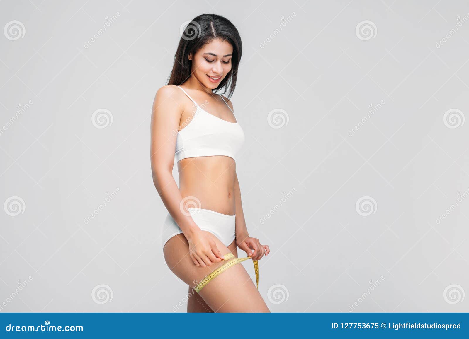 Beautiful Slim African American Girl in Underwear Measuring Her