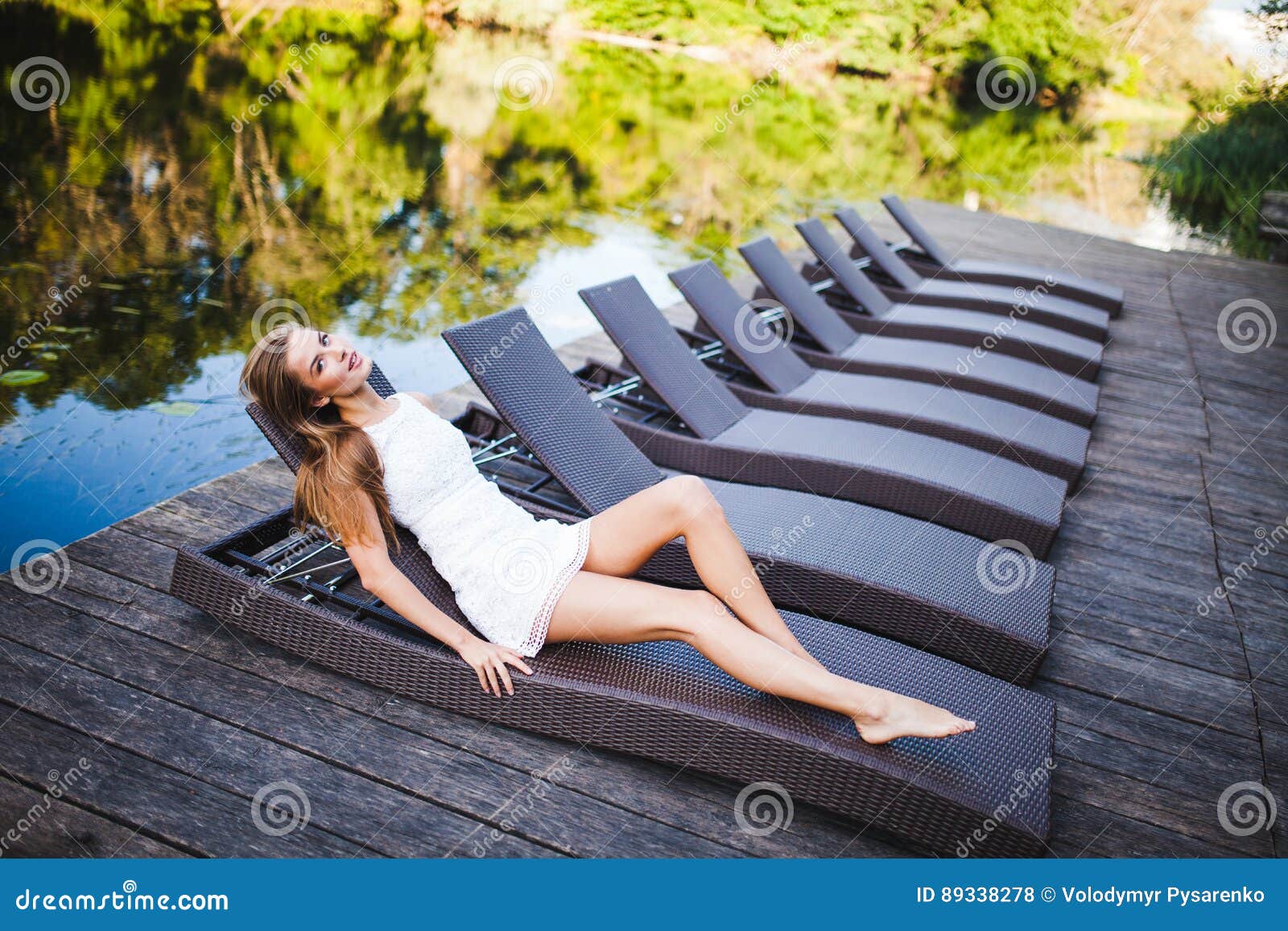Beautiful Slim Fashionable Girl Lying in a Deck Chair Near River ...