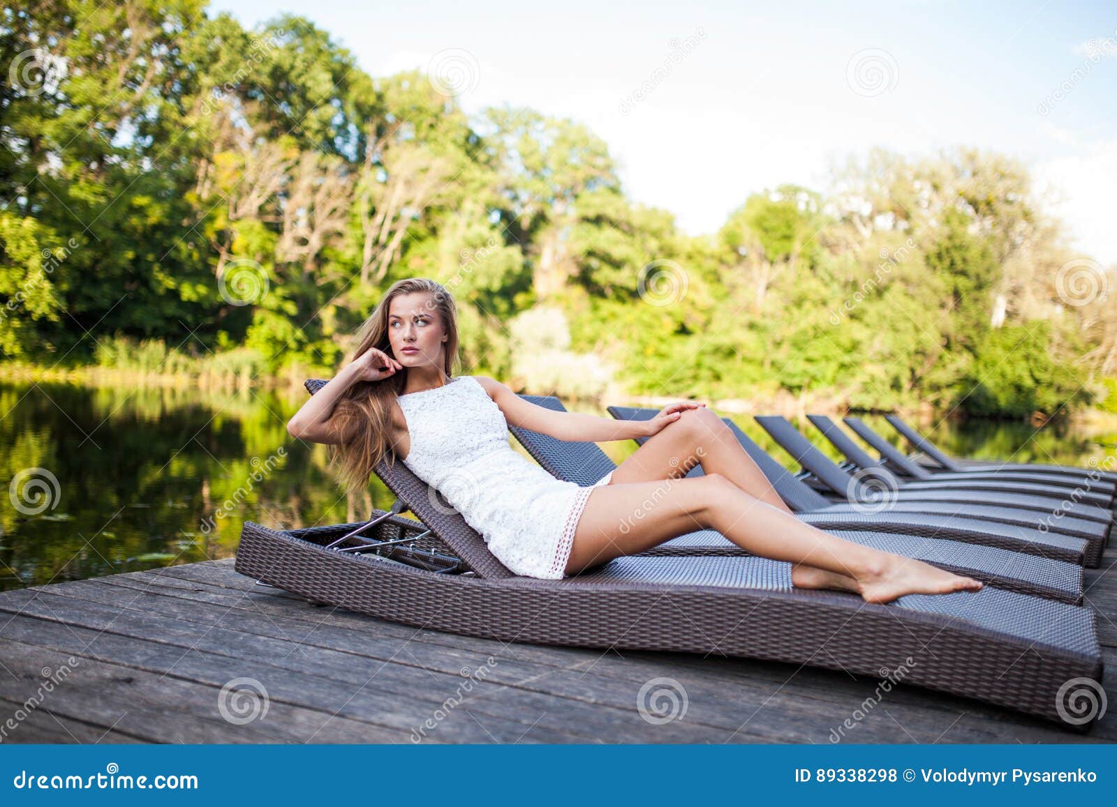 Beautiful Slim Fashionable Girl Lying in a Deck Chair Near River ...