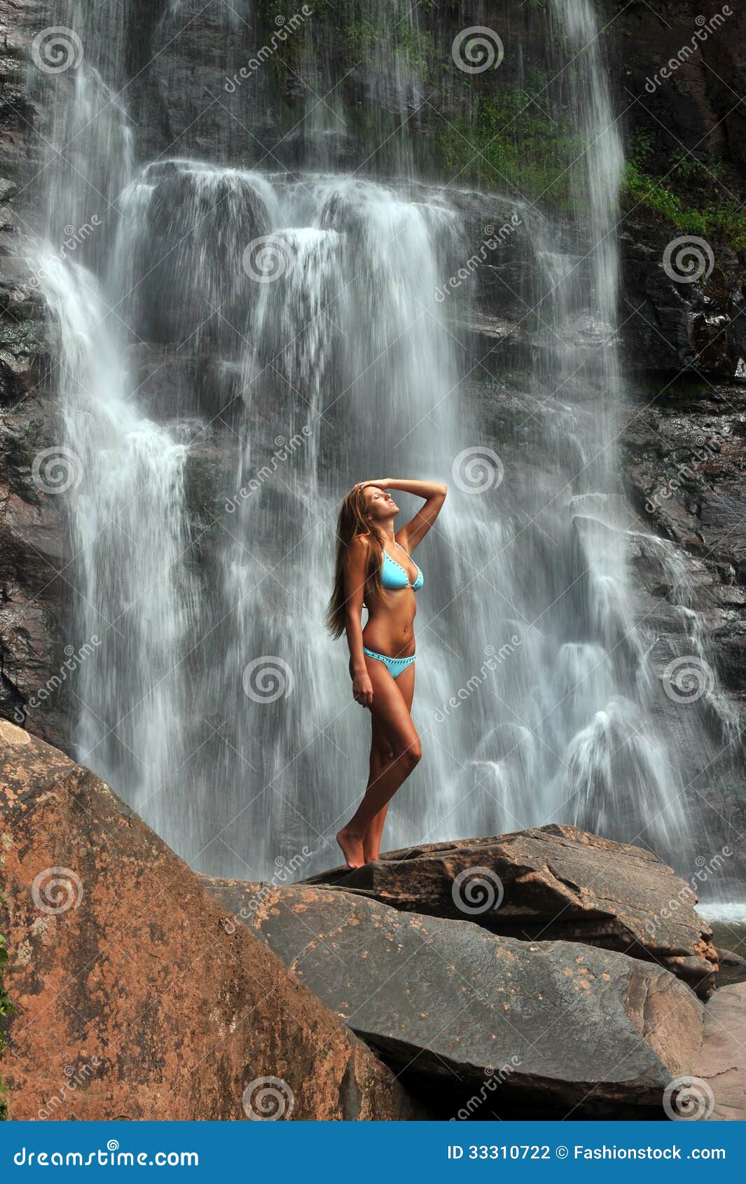 Beautiful Slim Fitness Model Posing In Front Of Waterfalls Stock