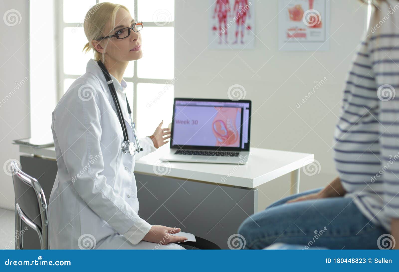 Beautiful Smiling Pregnant Woman With The Doctor At 