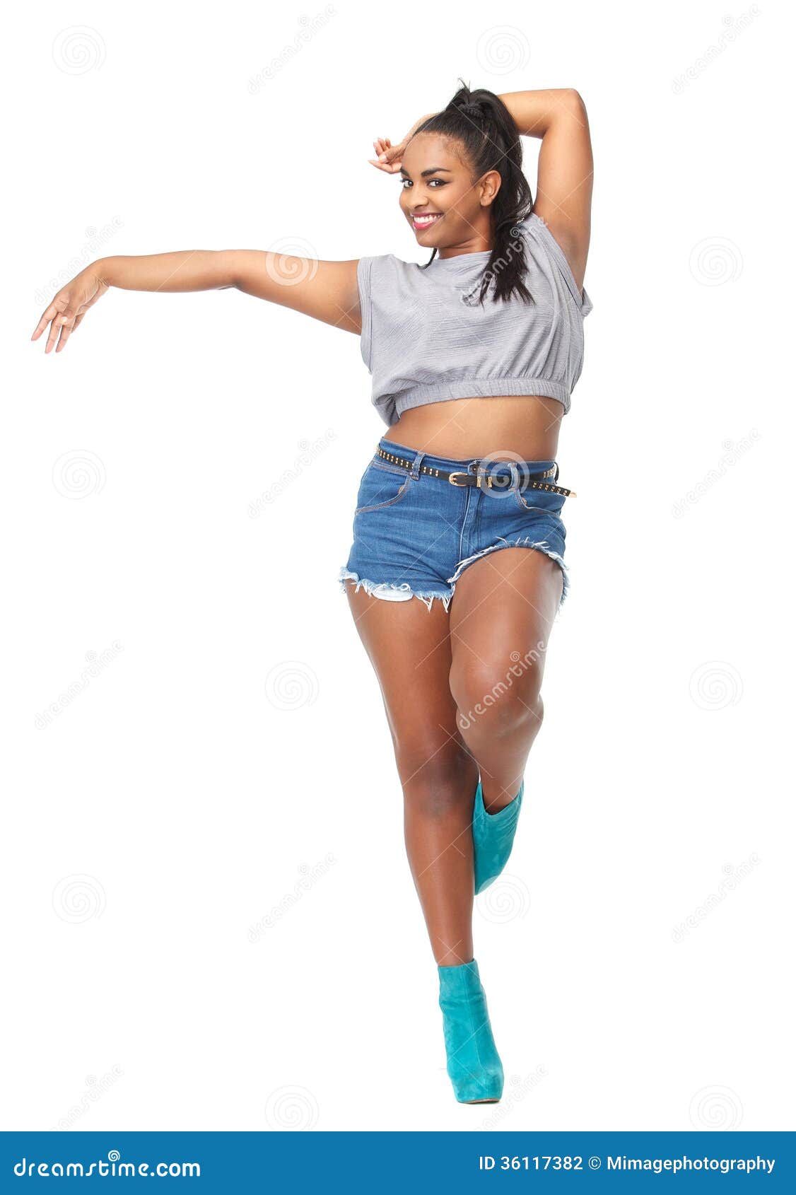 Full length portrait of a young slim fitness woman posing while standing  with hands on hips isolated over gray background Stock Photo - Alamy