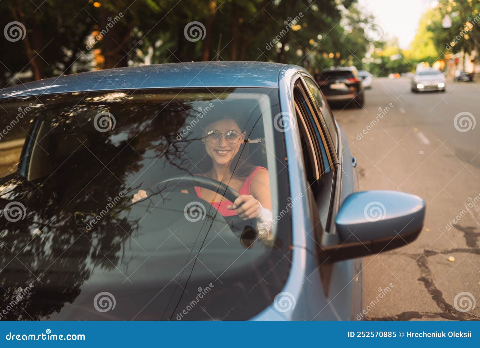 beautiful smiling woman driving car, girl sitting in automobile