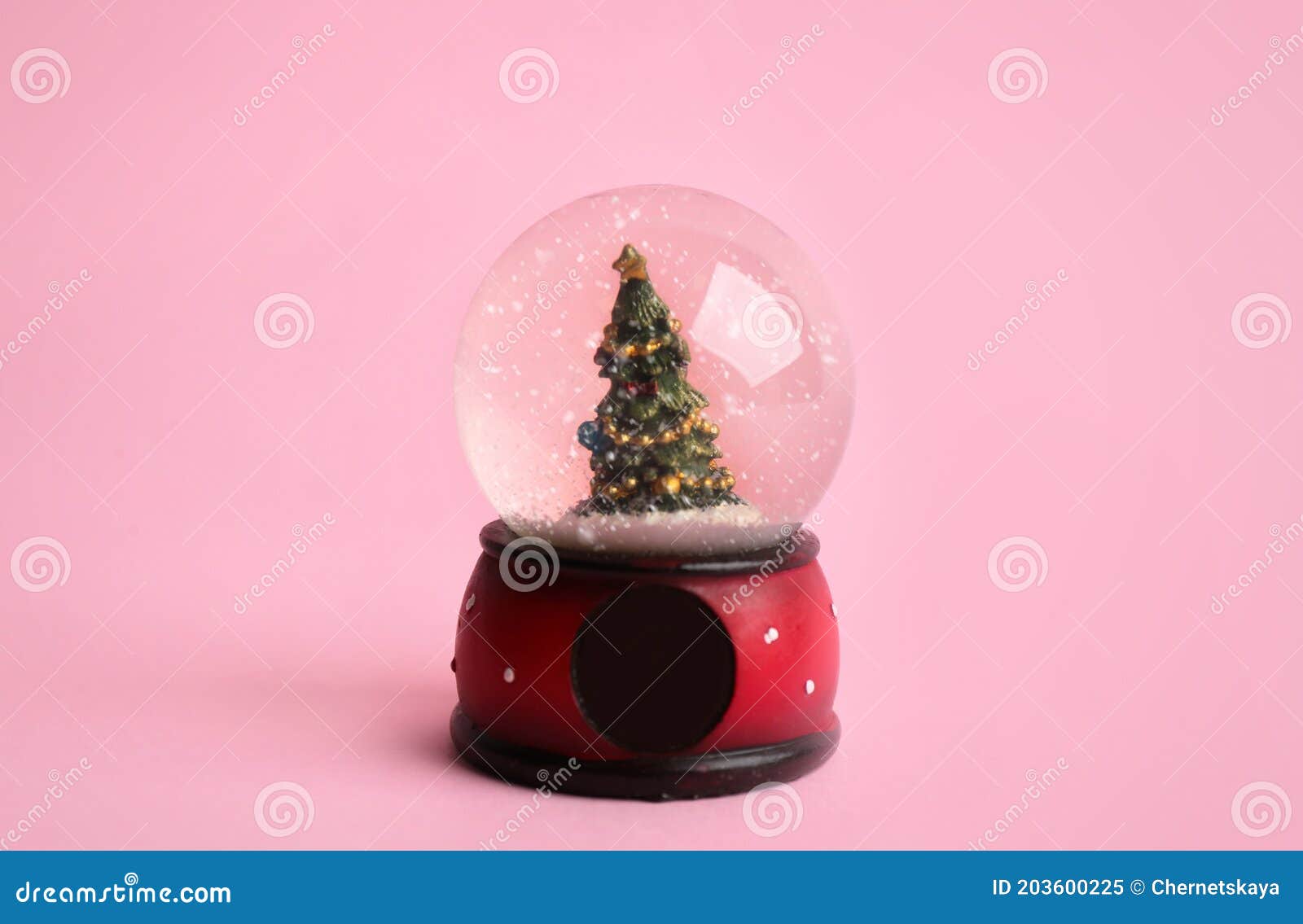 Beautiful Snow Globe with Christmas Tree on Pink Background Stock Image