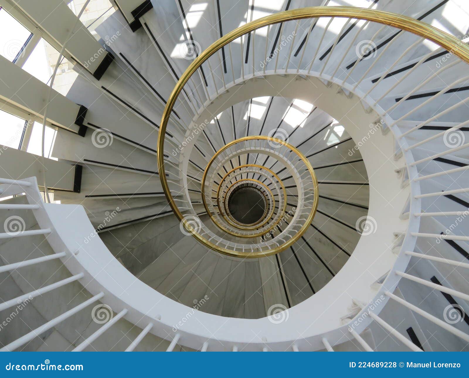 beautiful spiral staircase with golden handrails  circular s