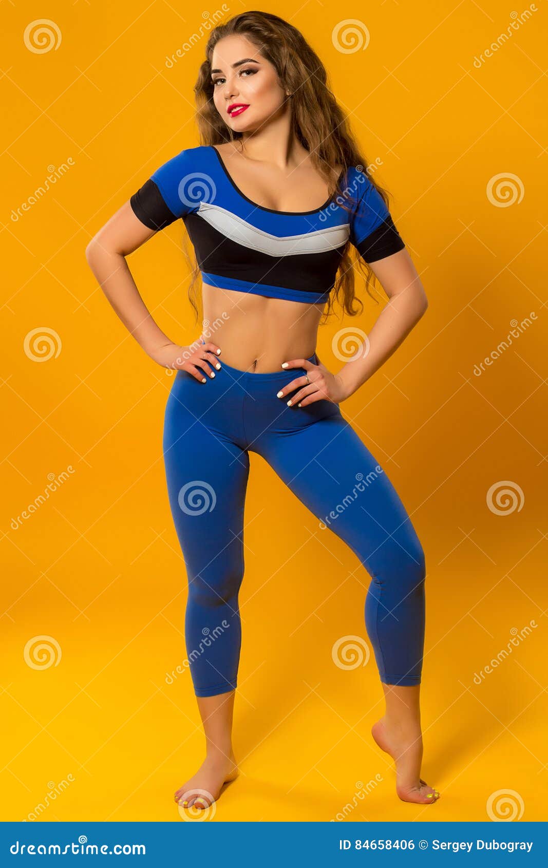 Beautiful Sports Girl Gymnast in Blue Sport Dress Posing Stock