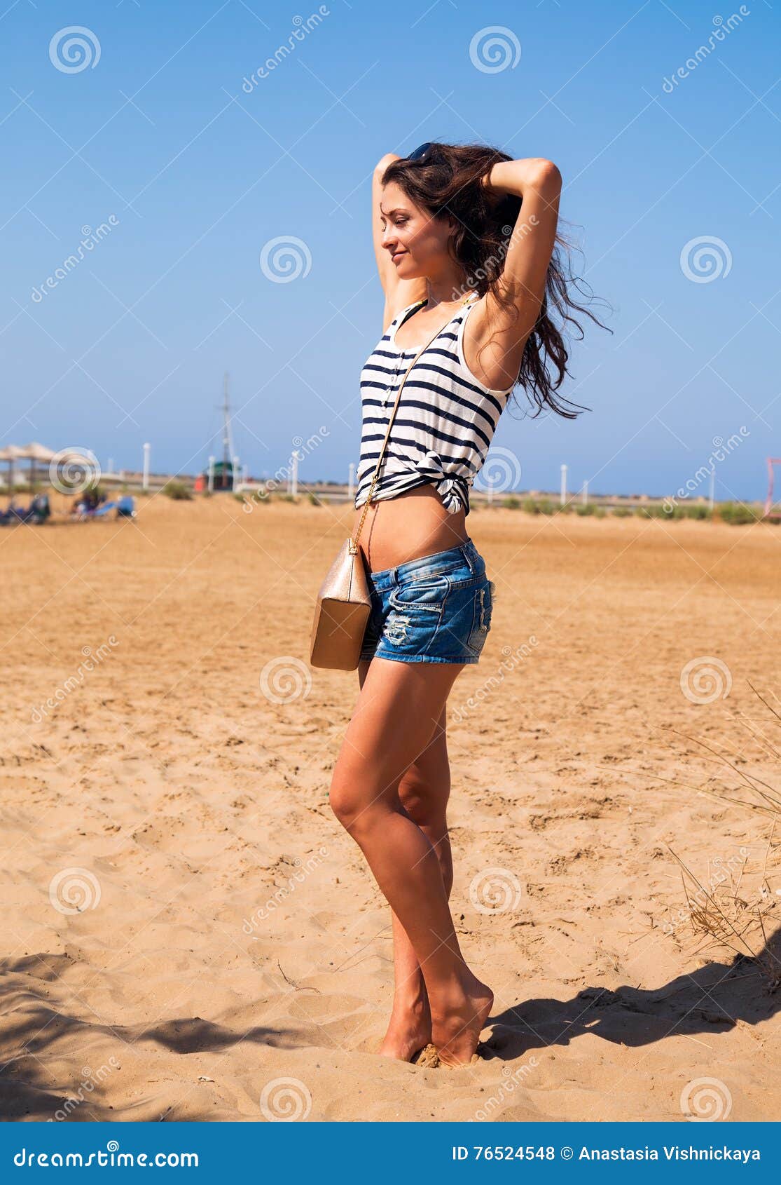 A Strong Girl With Big Muscular Arms On A Beach Stock Photo, Picture and  Royalty Free Image. Image 18043673.