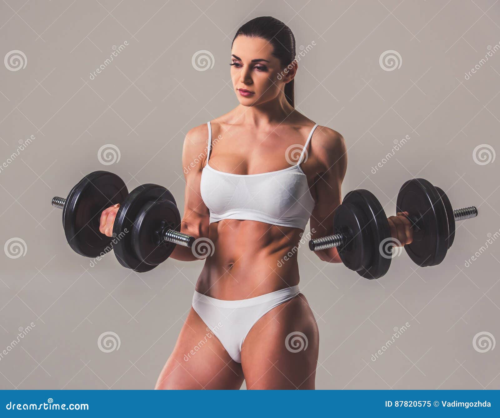 Woman in latex underwear and with dumbbells Stock Photo by ©fxquadro  23869087